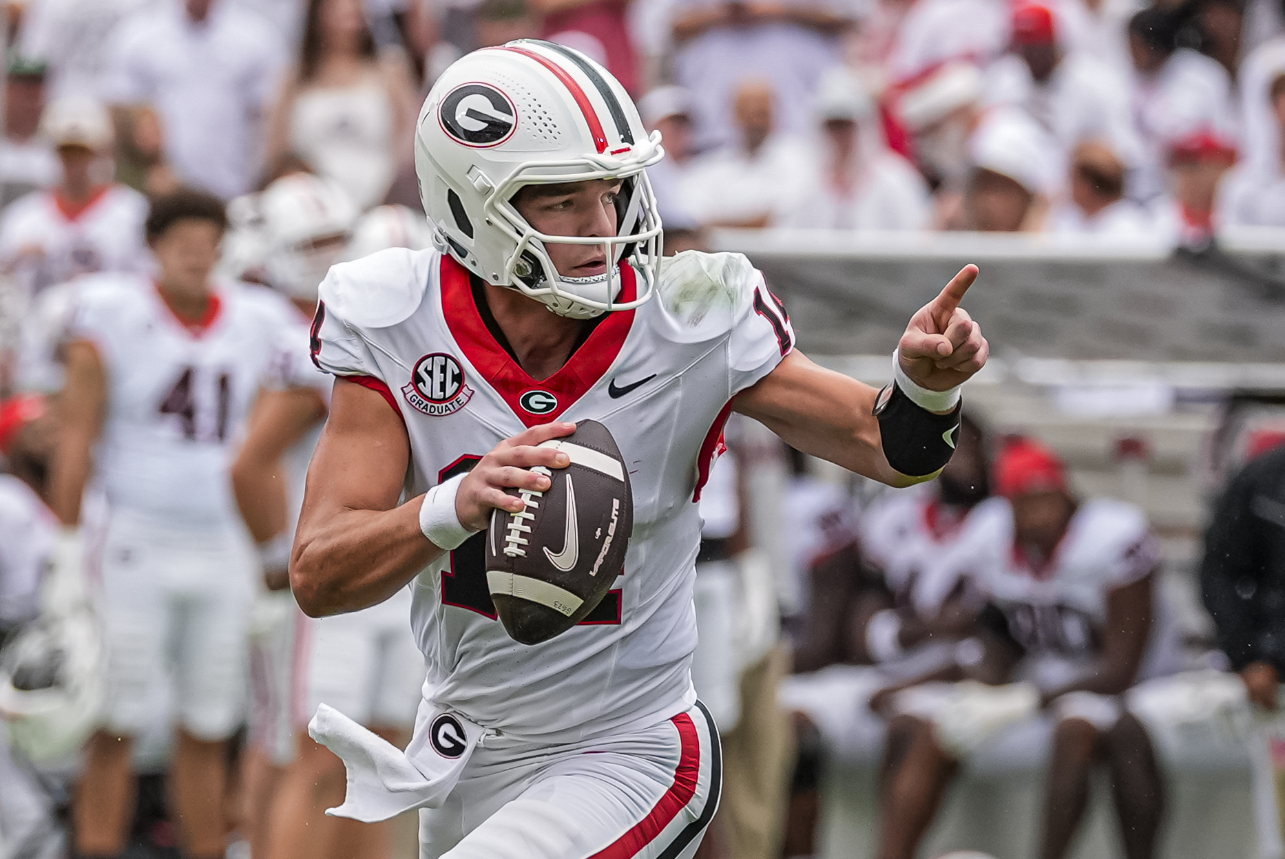 Georgia Bulldogs quarterback Gunner Stockton (14) rolls out as we break down our Georgia vs. Arkansas prediction.