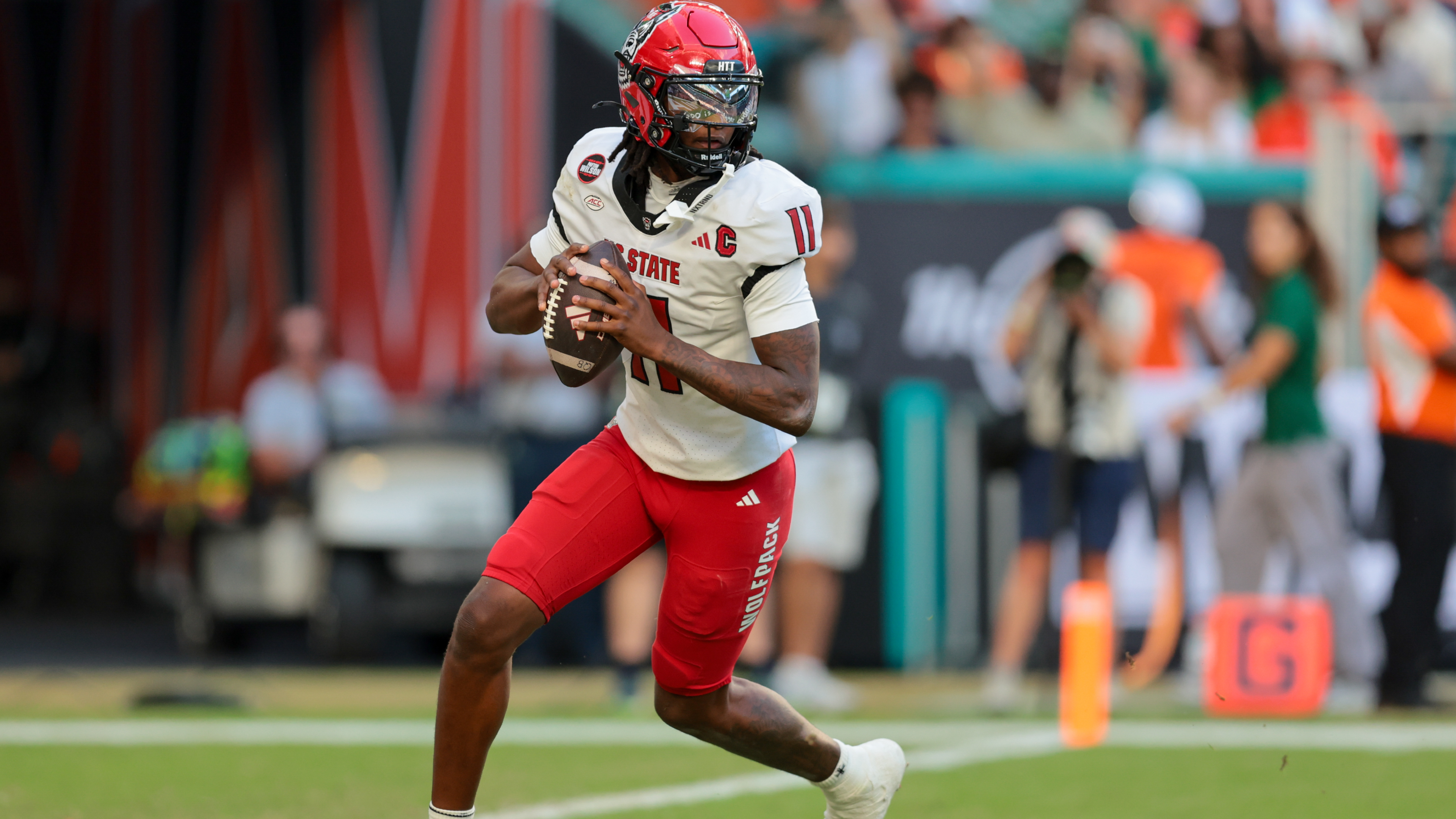 NC State Wolfpack quarterback CJ Bailey (11) drops back as he is featured in our North Carolina State vs. Virginia prediction.