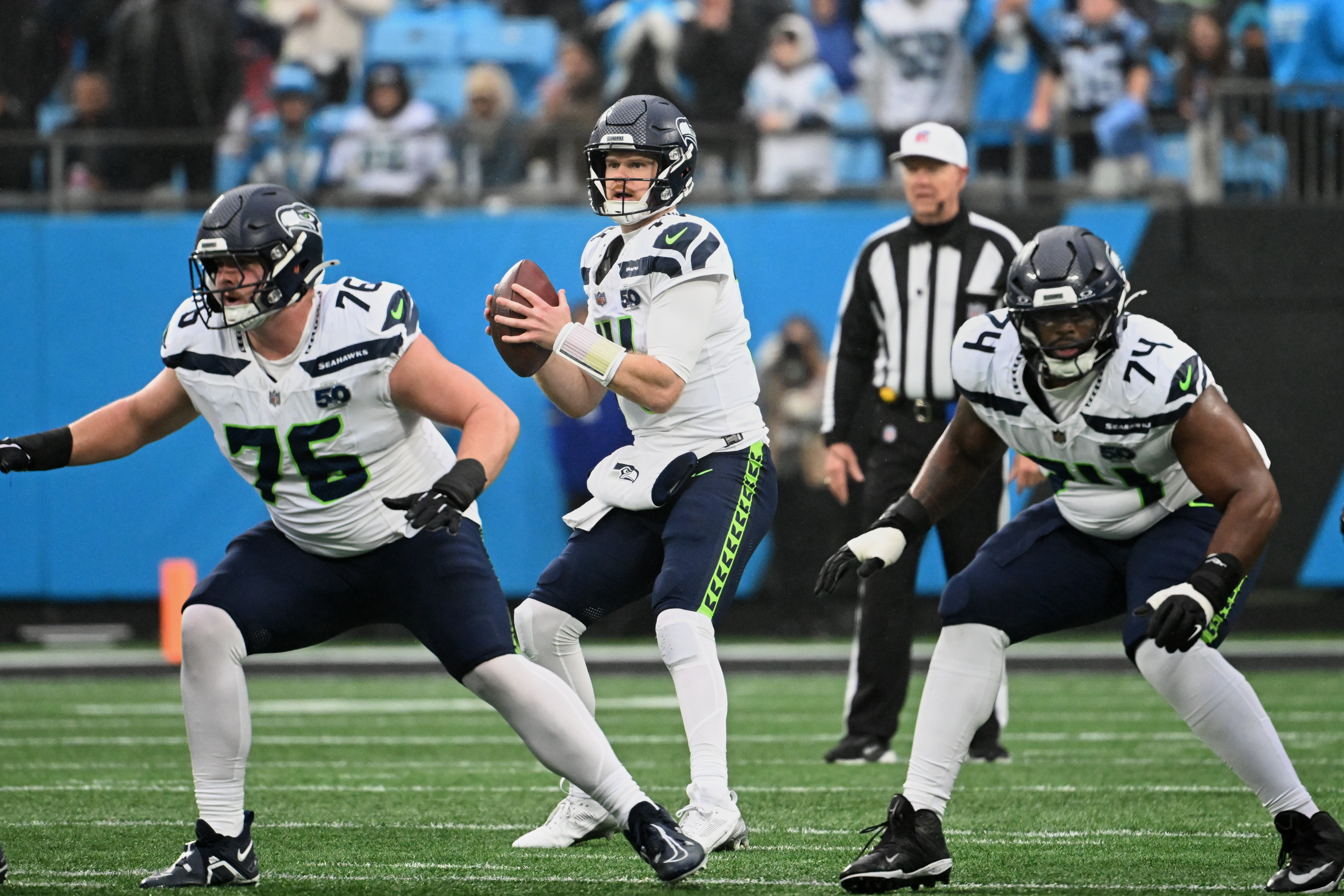 Seattle Seahawks quarterback Sam Darnold (14) looks to throw a pass as guards Grey Zabel (76) and Josh Jones (74) block, and we look at the Super Bowl odds and NFL futures