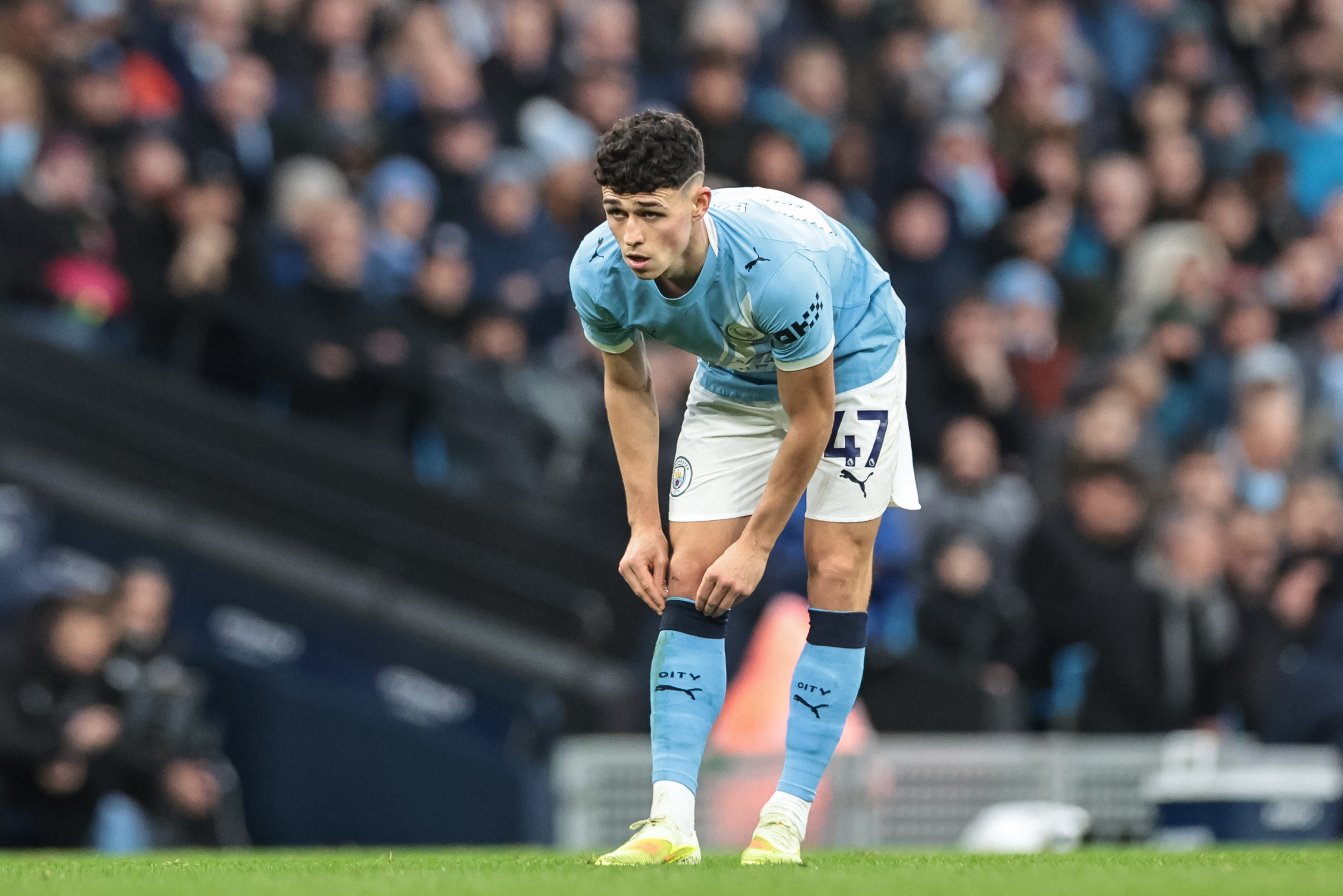 Phil Foden of Manchester City pulls his socks up as we make our Man City vs. Fulham prediction.