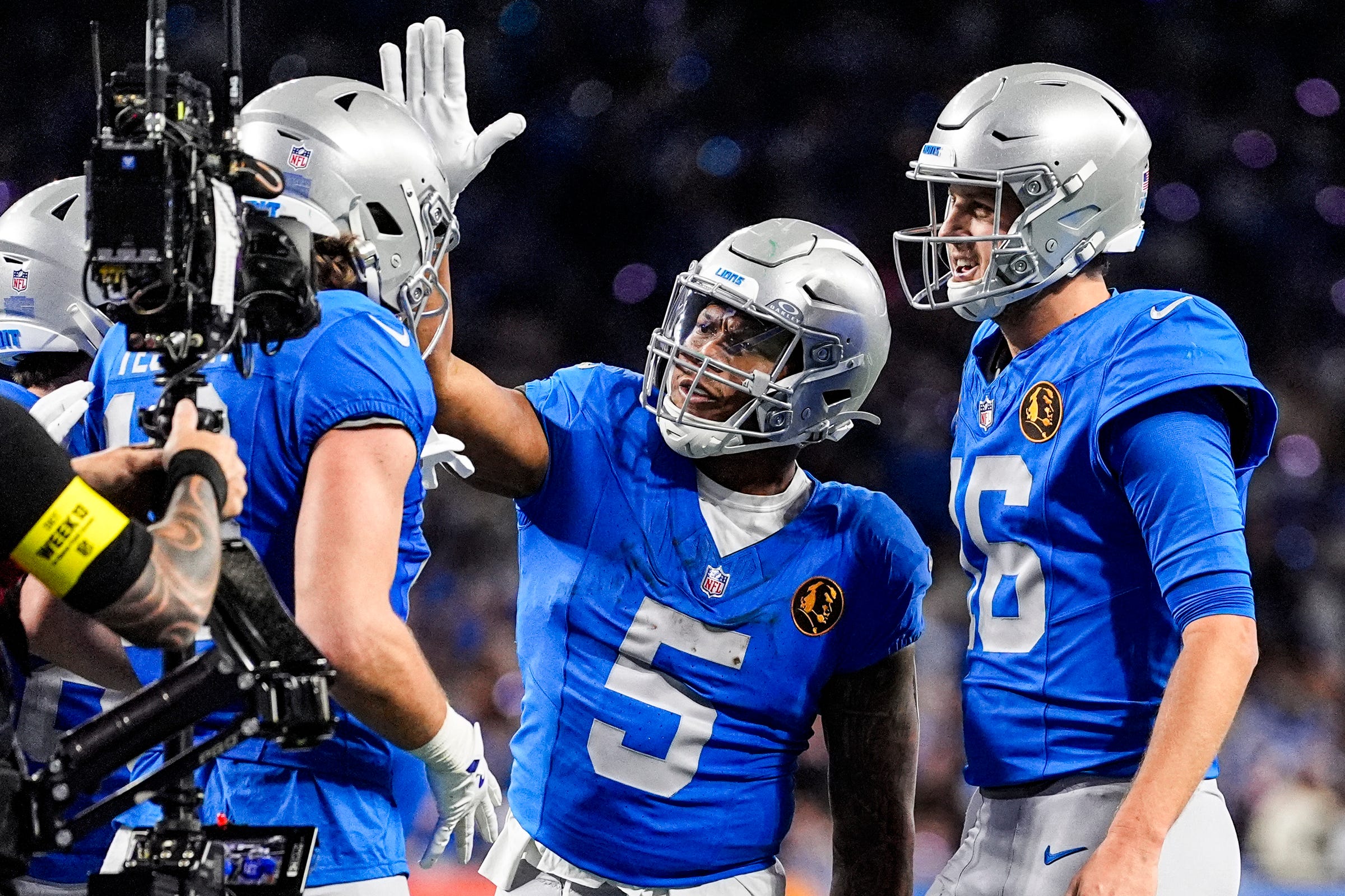 Detroit Lions wide receiver Isaac TeSlaa (18) celebrates a touchdown against against Green Bay Packers with running back David Montgomery (5) and quarterback Jared Goff (16).