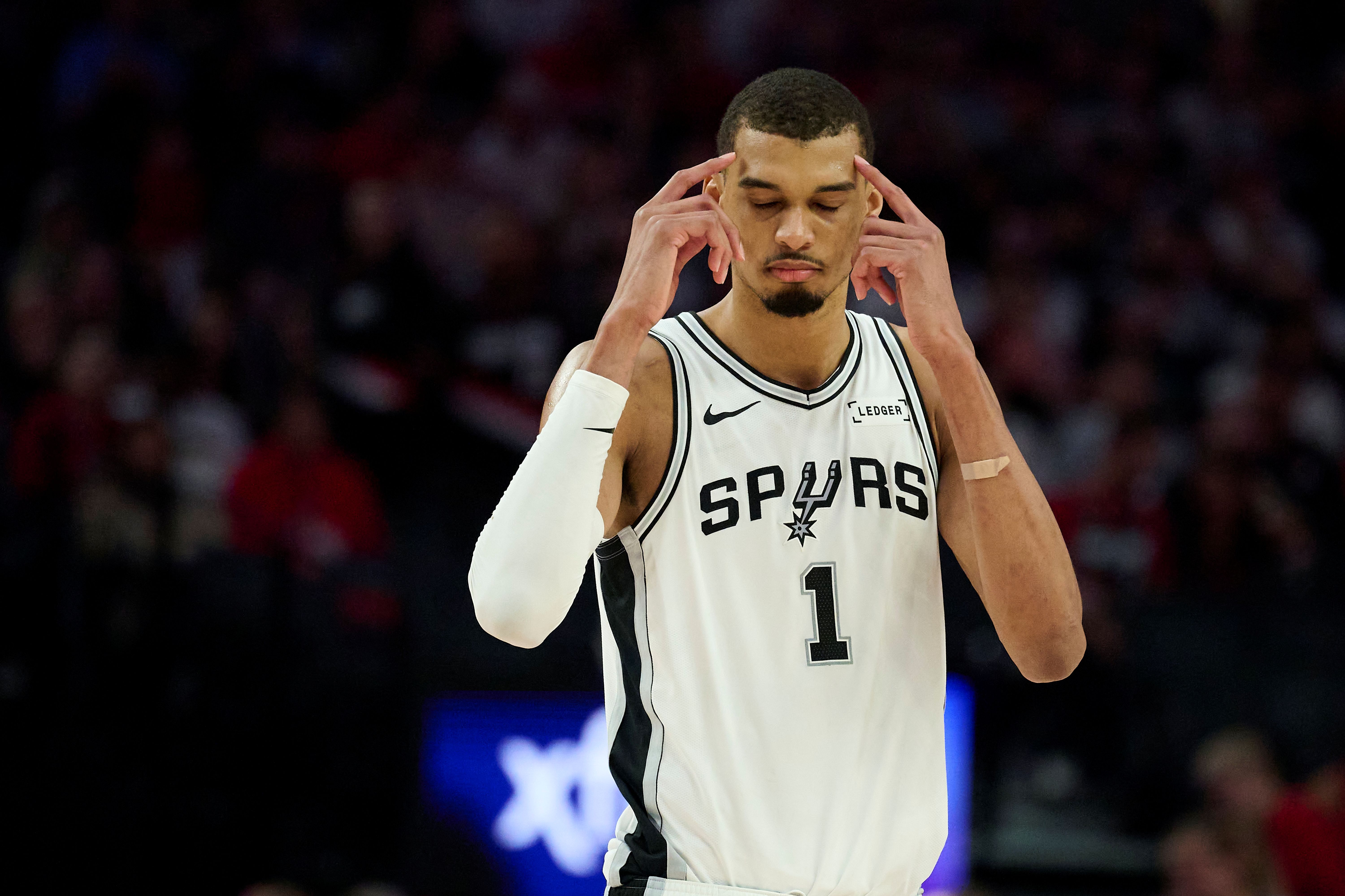 San Antonio Spurs forward Victor Wembanyama (1), seen here reacting during a game, is featured in our NBA player props today.