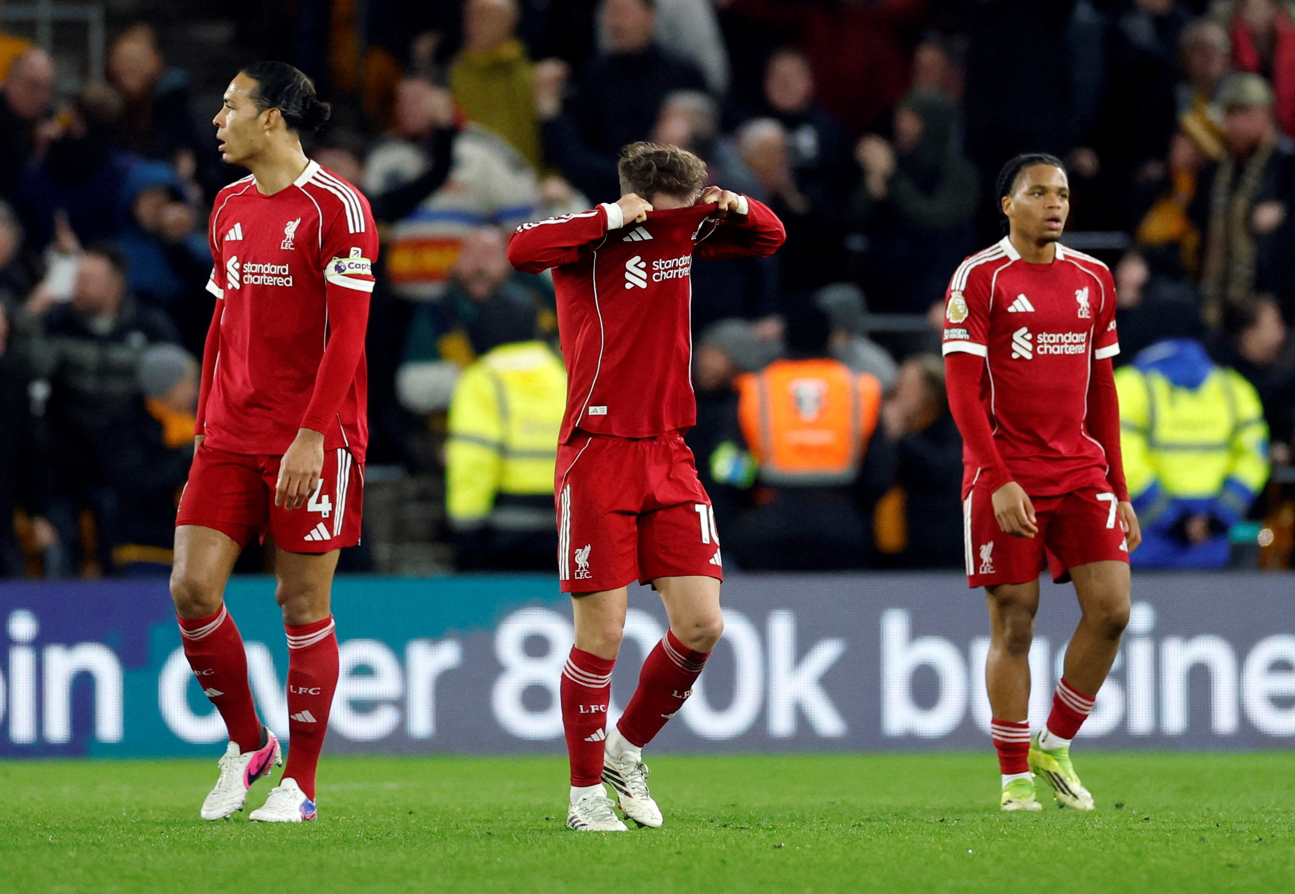 Liverpool's Alexis Mac Allister, Virgil van Dijk, and Rio Ngumoha look dejected as we make our best Everton vs. Liverpool prediction.