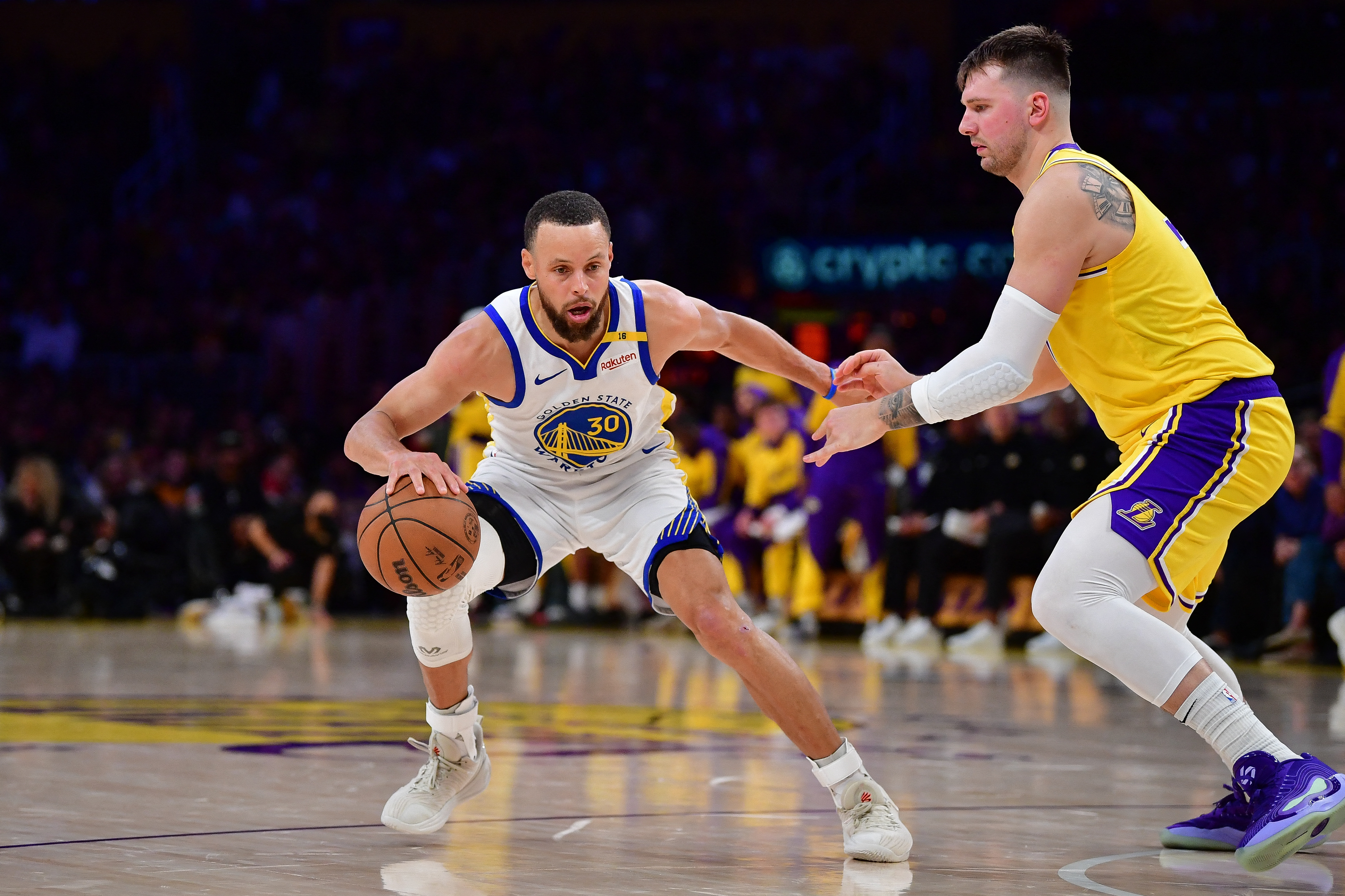 Golden State Warriors guard Stephen Curry (30) controls the ball against Los Angeles Lakers guard Luka Doncic (77) as we provide our Warriors vs. Lakers prediction.