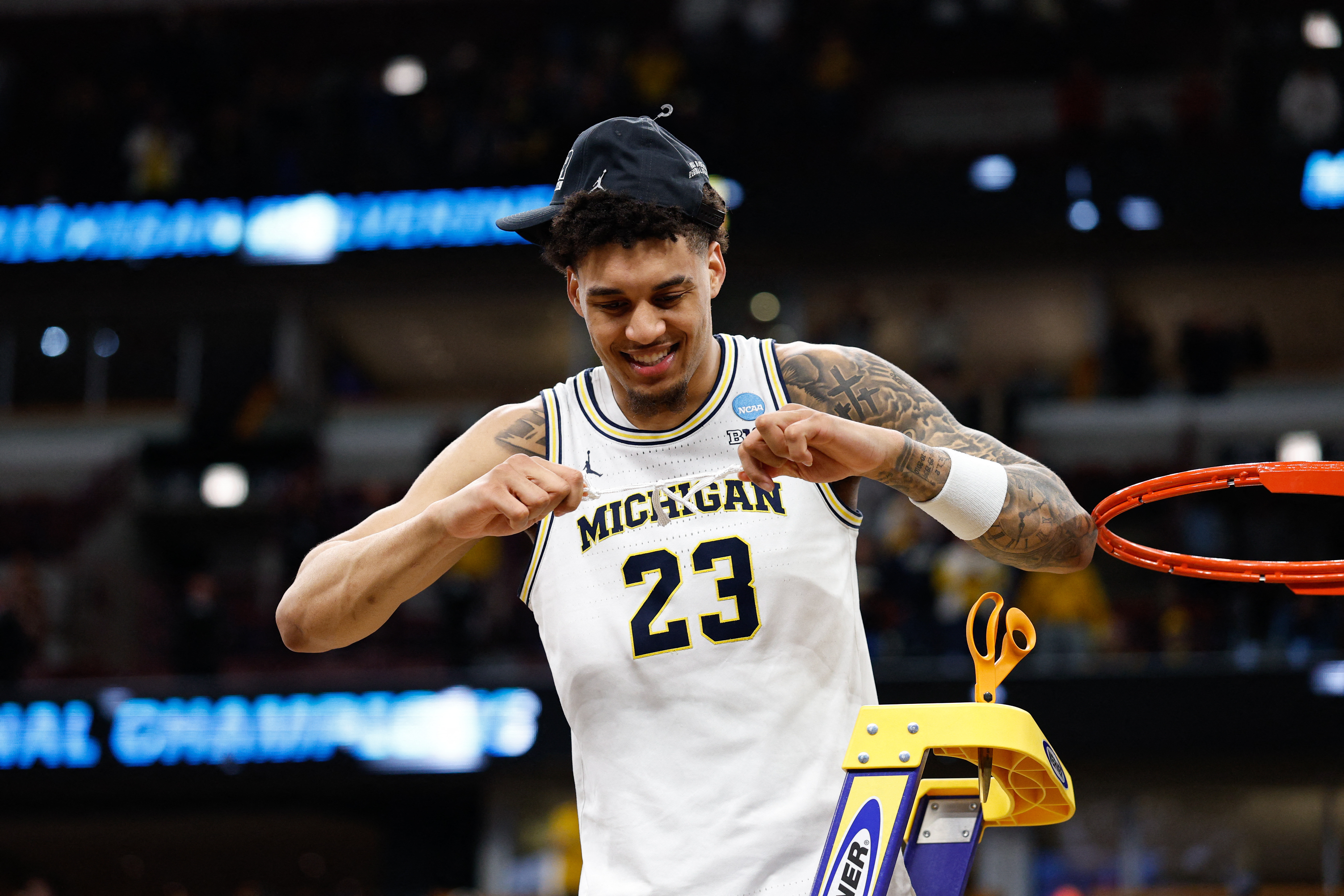Michigan Wolverines forward Yaxel Lendeborg (23), who has the highest March Madness MVP win probability, cuts the net after defeating Tennessee Volunteers in the Elite Eight of the 2026 NCAA Tournament.