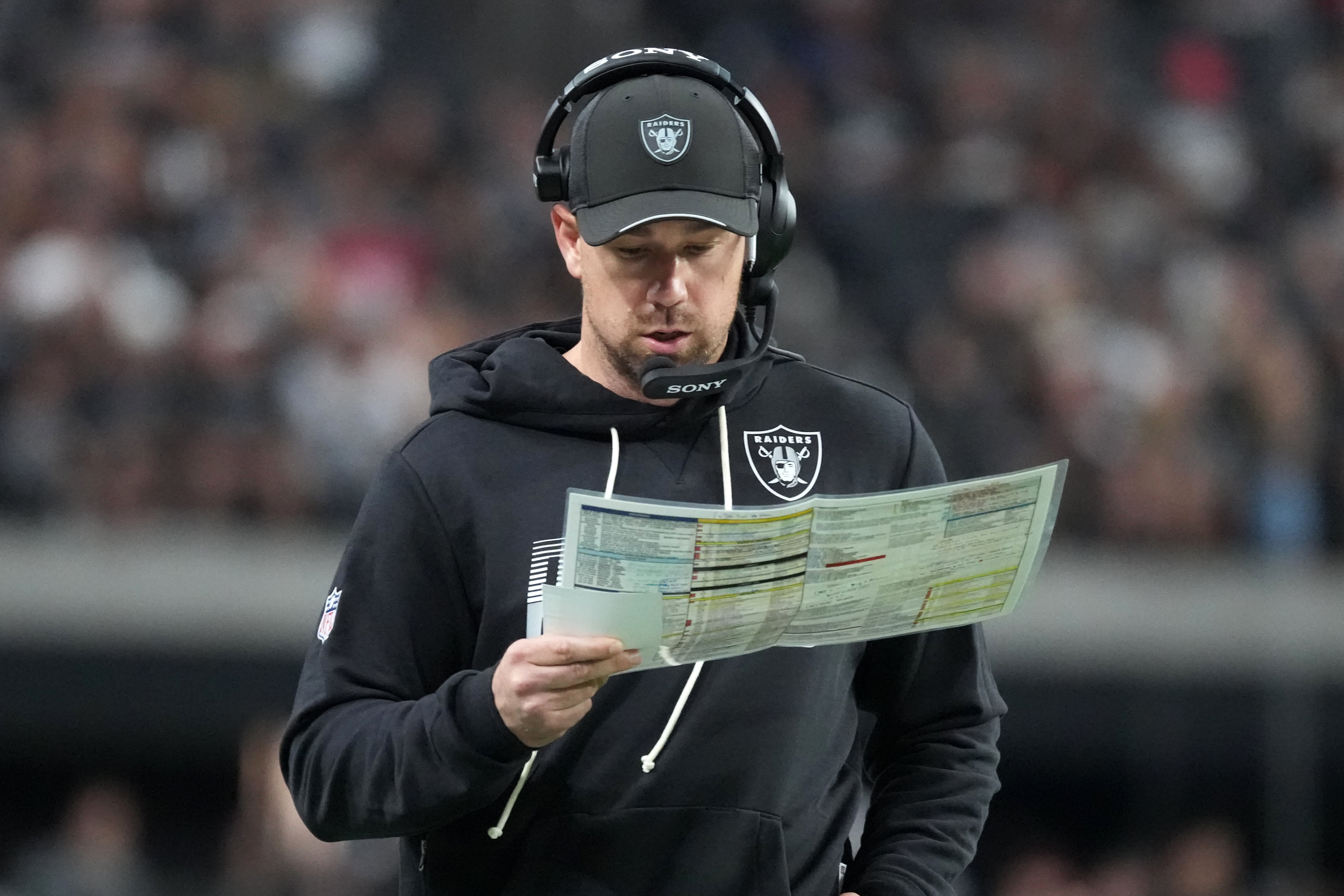 Las Vegas Raiders head coach Klint Kubiak looks down as we break down our 49ers vs. Raiders prediction.
