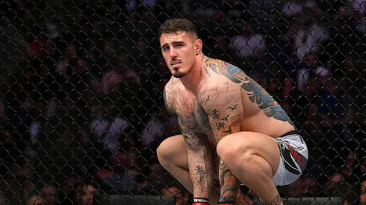 Tom Aspinall (red gloves) prior to the fight against Marcin Tybura (blue gloves) as we look at our best UFC 321 predictions