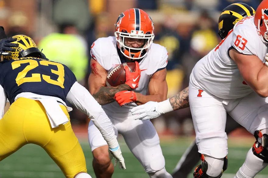 Chase Brown of the Illinois Fighting Illini looks for yards against the Michigan Wolverines.