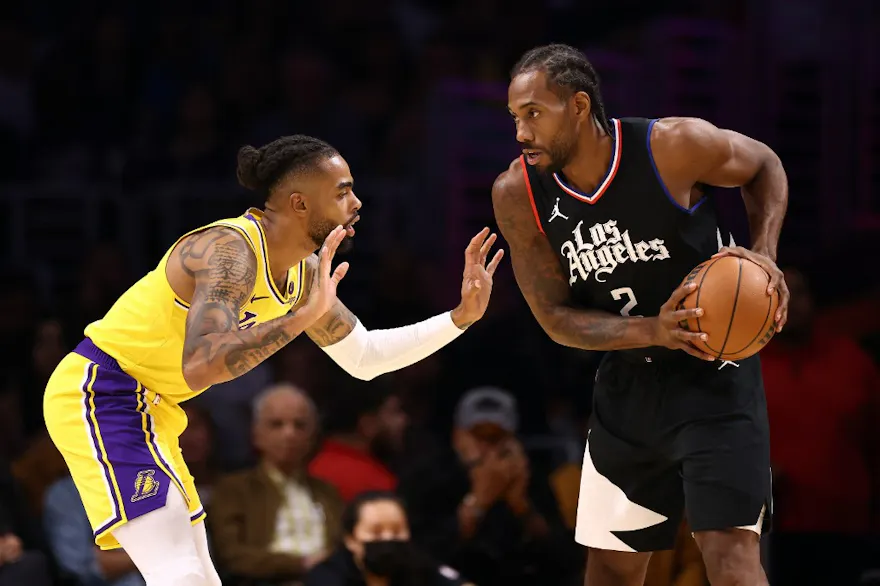 Kawhi Leonard #2 of the Los Angeles Clippers handles the ball against D'Angelo Russell #1 of the Los Angeles Lakers, as we make our Lakers vs. Clippers NBA player props picks and predictions for Wednesday.