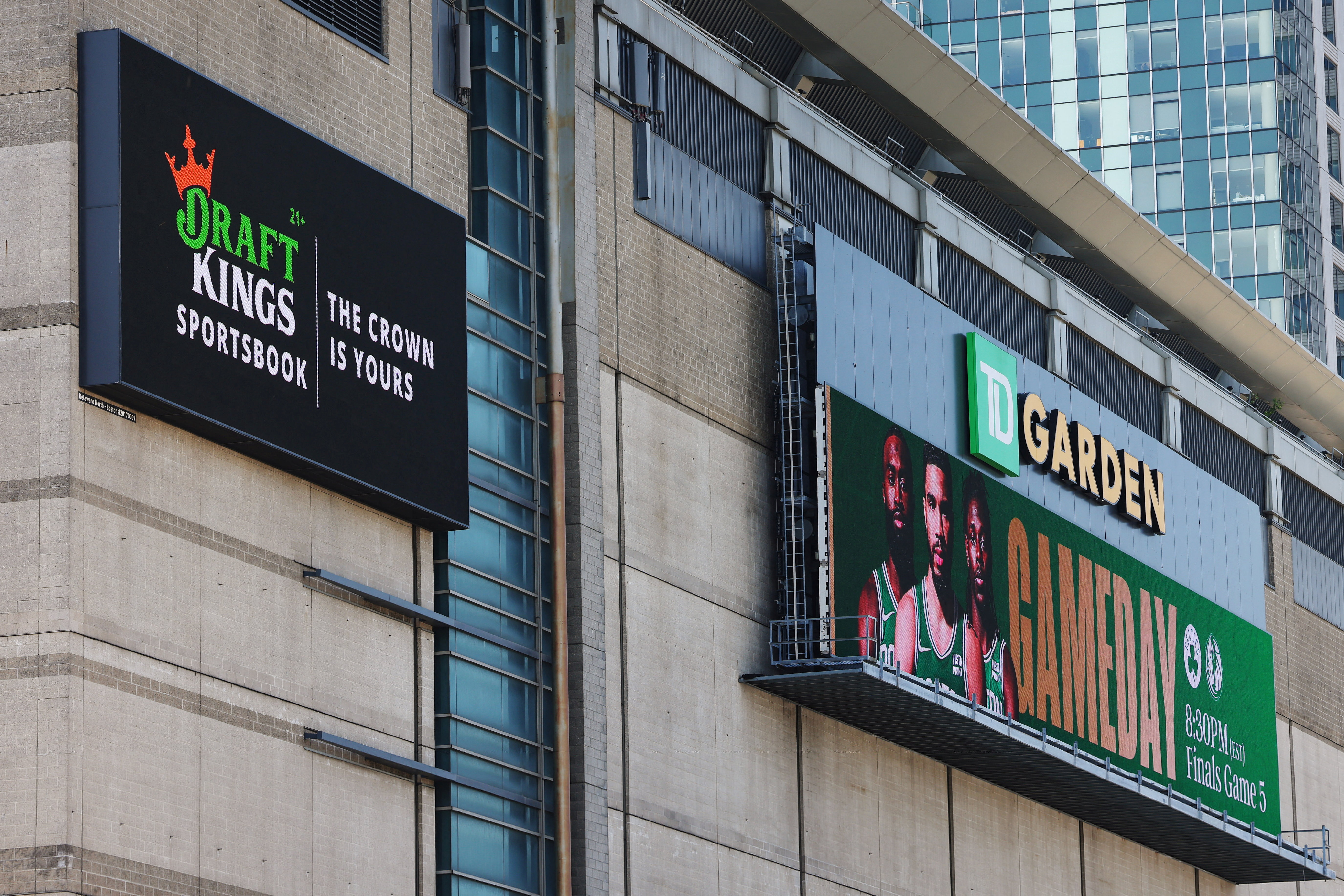 An advertisement for the online sports betting company DraftKings Sportsbook hangs on the side of the Boston Garden as look at the state asking operators about the use of AI. 