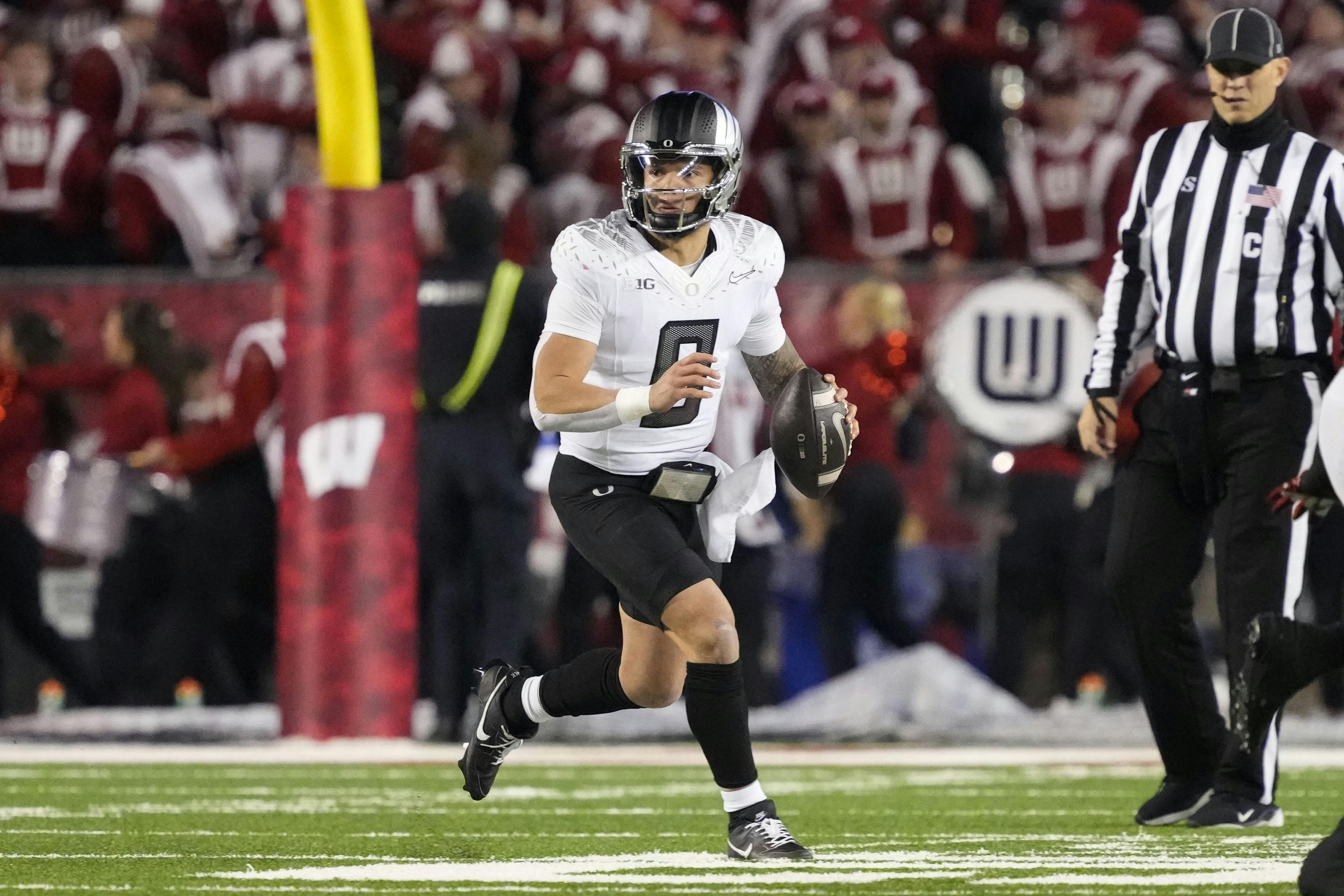 Oregon quarterback Dillon Gabriel looks to throw a pass against Wisconsin. The Ducks sit behind the Buckeyes by the Big Ten Championship odds.