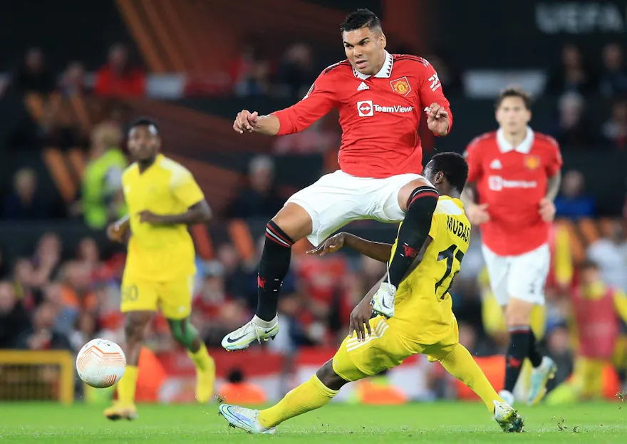 Manchester United's Brazilian midfielder Casemiro jumps a challenge from FC Sheriff's Ghanaian midfielder Salifu Mudasiru during the UEFA Europa League Group E football match between Manchester United and Sheriff Tiraspol.