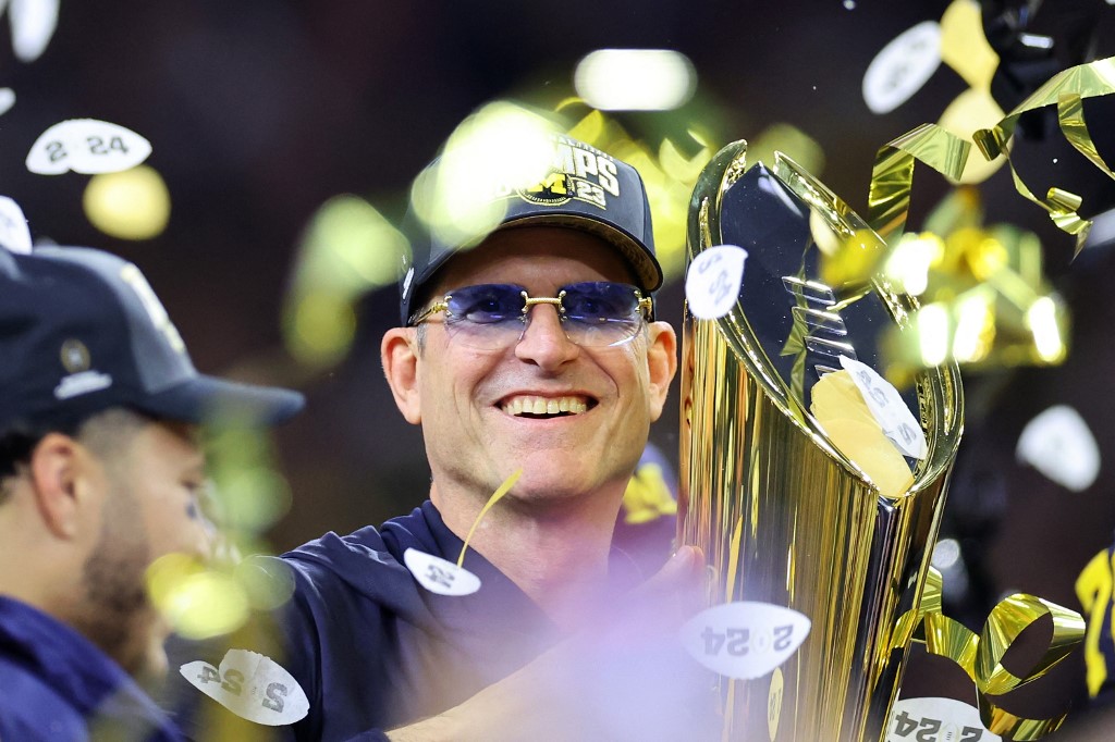Head coach Jim Harbaugh of the Michigan Wolverines celebrates