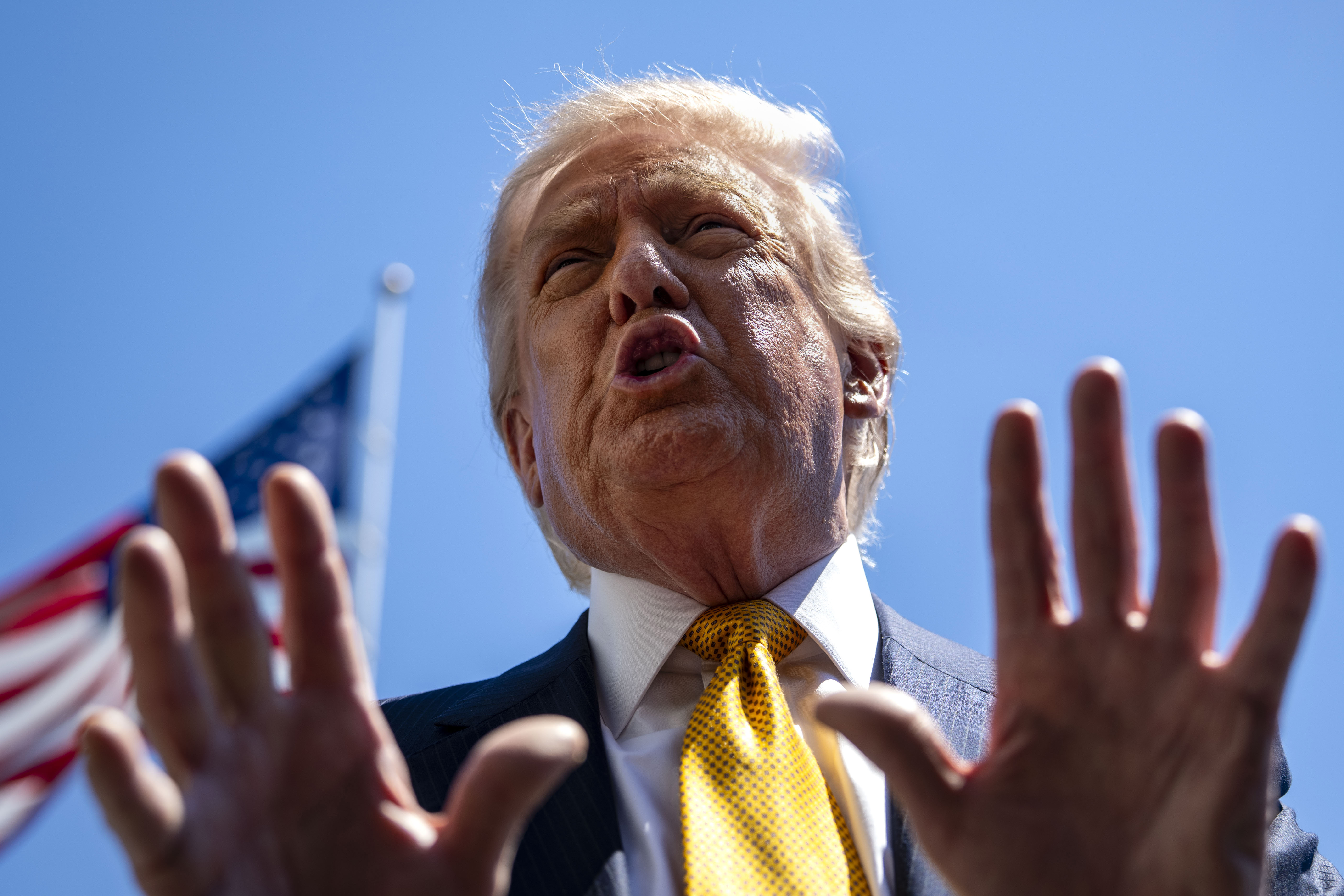 President Donald Trump speaks to the press before departing the White House