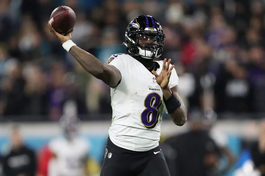 Lamar Jackson #8 of the Baltimore Ravens throws a touchdown pass as we look at our best NFL predictions for Week 16