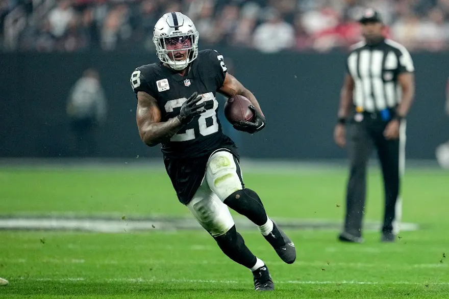 Josh Jacobs of the Las Vegas Raiders carries the ball against the Kansas City Chiefs as we look at our NFL expert picks.