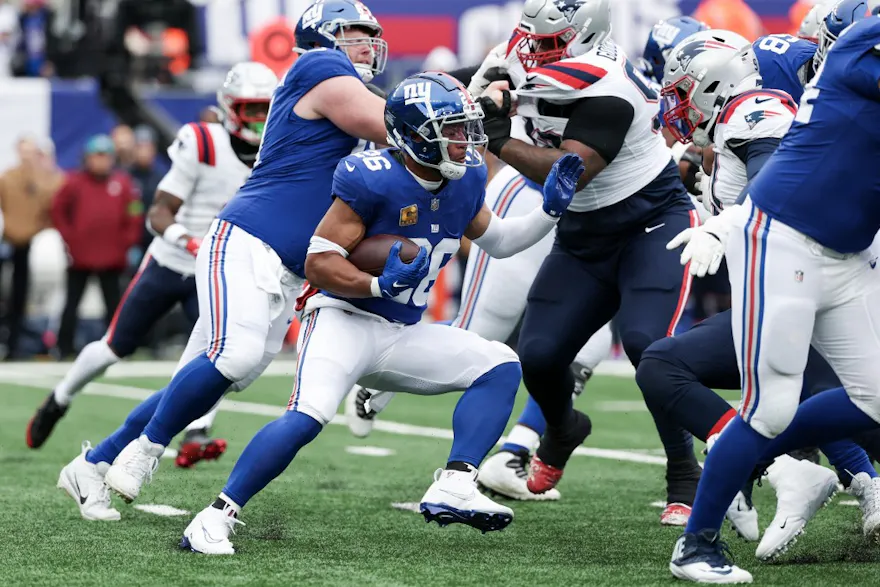 Saquon Barkley of the New York Giants carries the ball ahead of our Week 14 NFL predictions for Packers vs. Giants