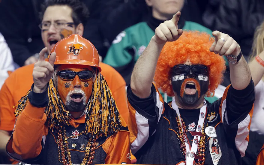 Fans of the B.C. Lions celebrate a play against the Winnipeg Blue Bombers during the CFL 99th Grey Cup November 27, 2011 at BC Place in Vancouver, British Columbia, Canada.