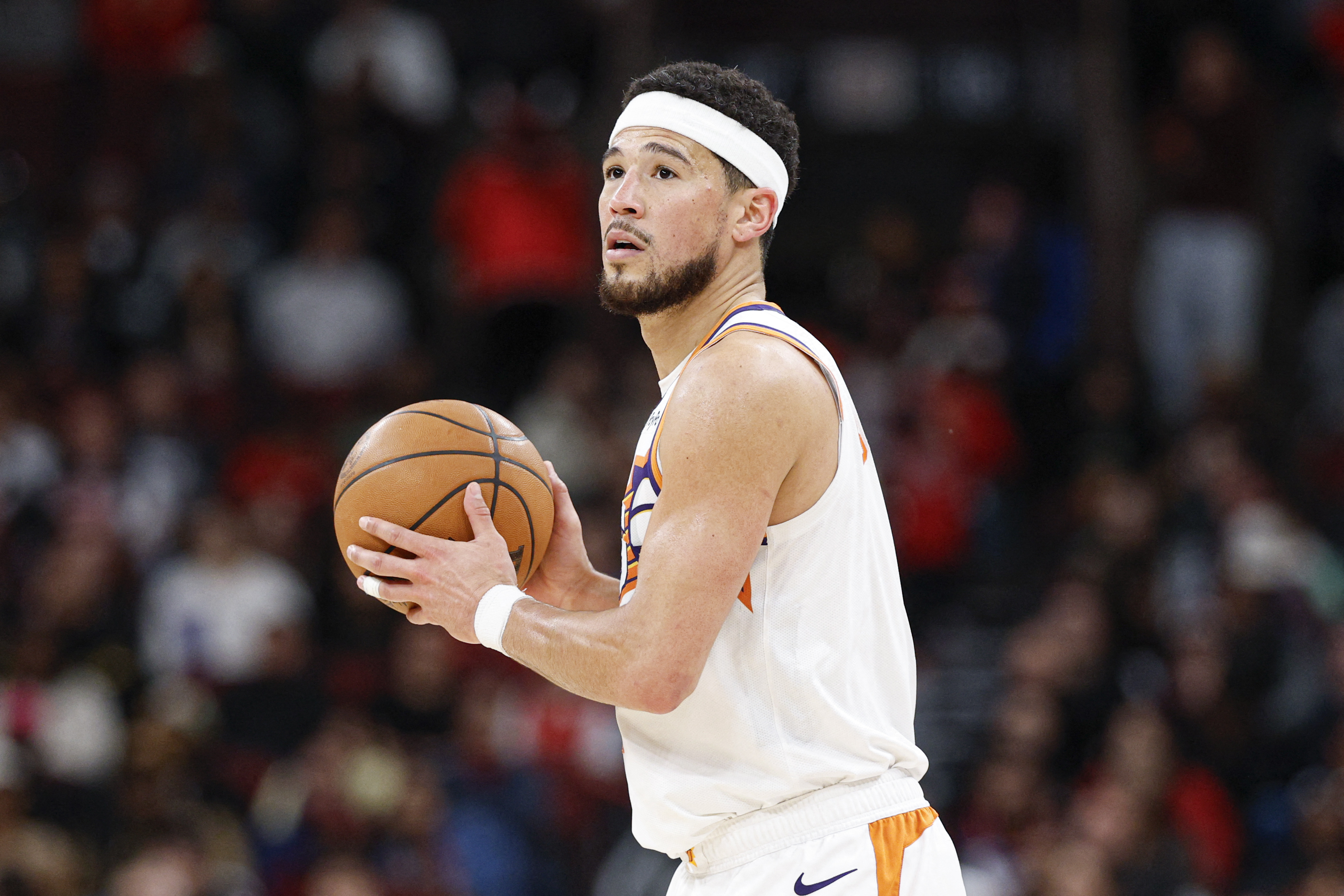 Phoenix Suns guard Devin Booker (1), seen here looking to pass during a game, is featured in our NBA player props today.
