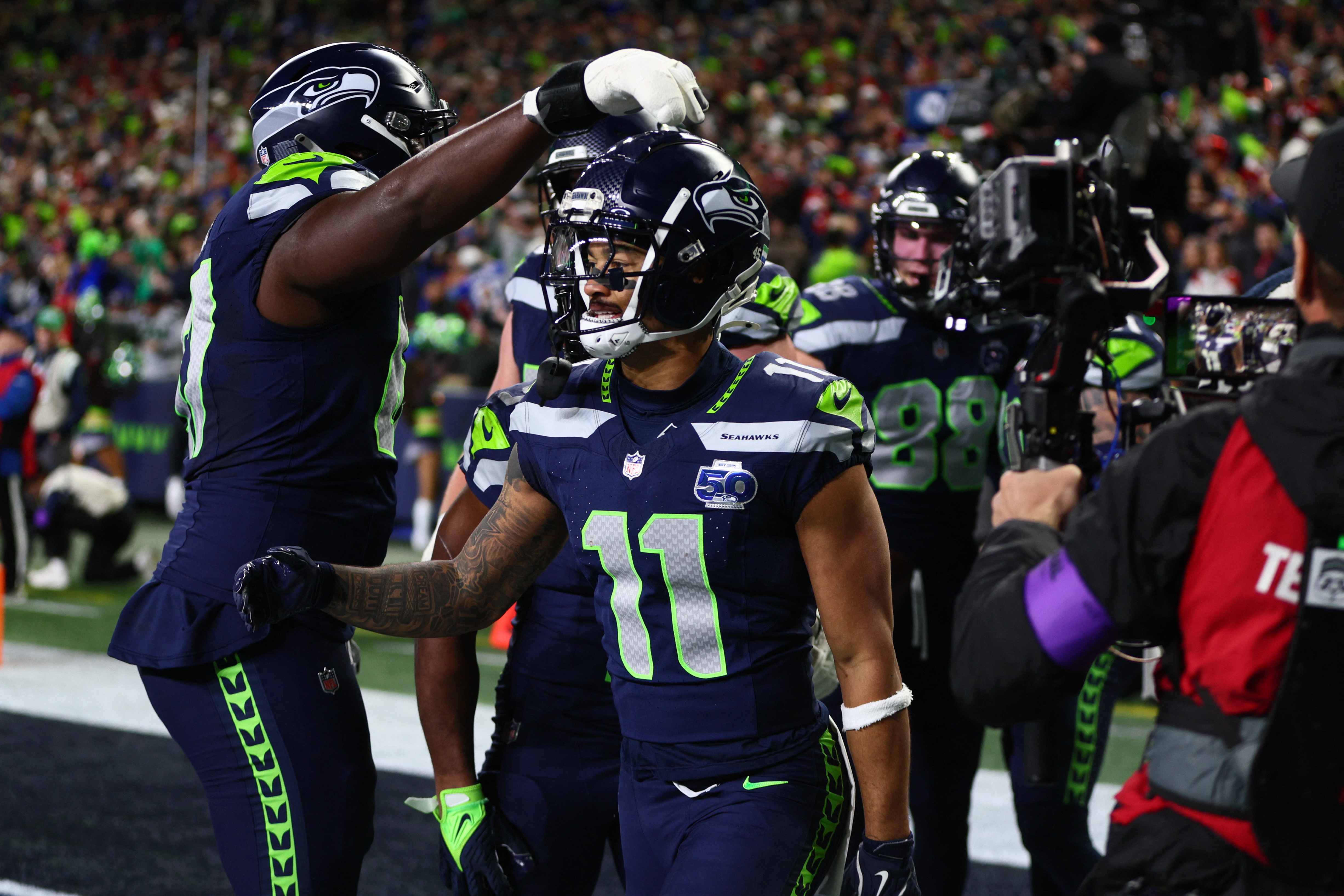 Seattle Seahawks wide receiver Jaxon Smith-Njigba (11), who leads our Super Bowl MVP predictions, reacts with teammates after catching a touchdown pass.