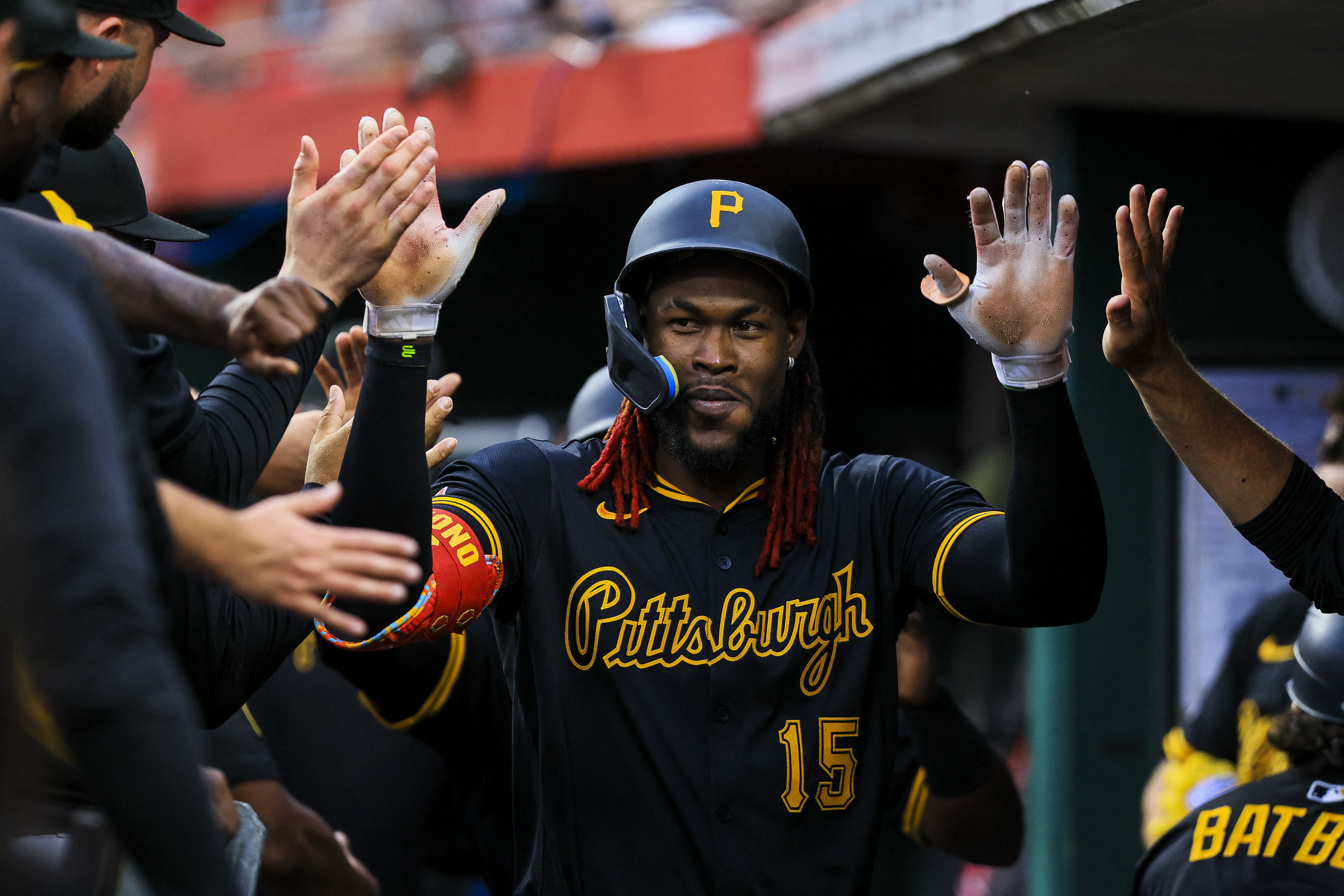 Pittsburgh Pirates outfielder Oneil Cruz (15), seen here high-fiving his teammates, is projected to hit a home run in our Pirates vs. Mets prediction today.