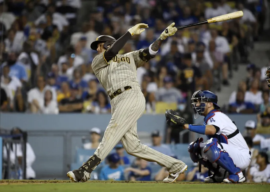 Manny Machado #13 of the San Diego Padres hits a solo home run against starting pitcher Julio Urias #7 of the Los Angeles Dodgers during the sixth inning at Dodger Stadium on Sept. 3.