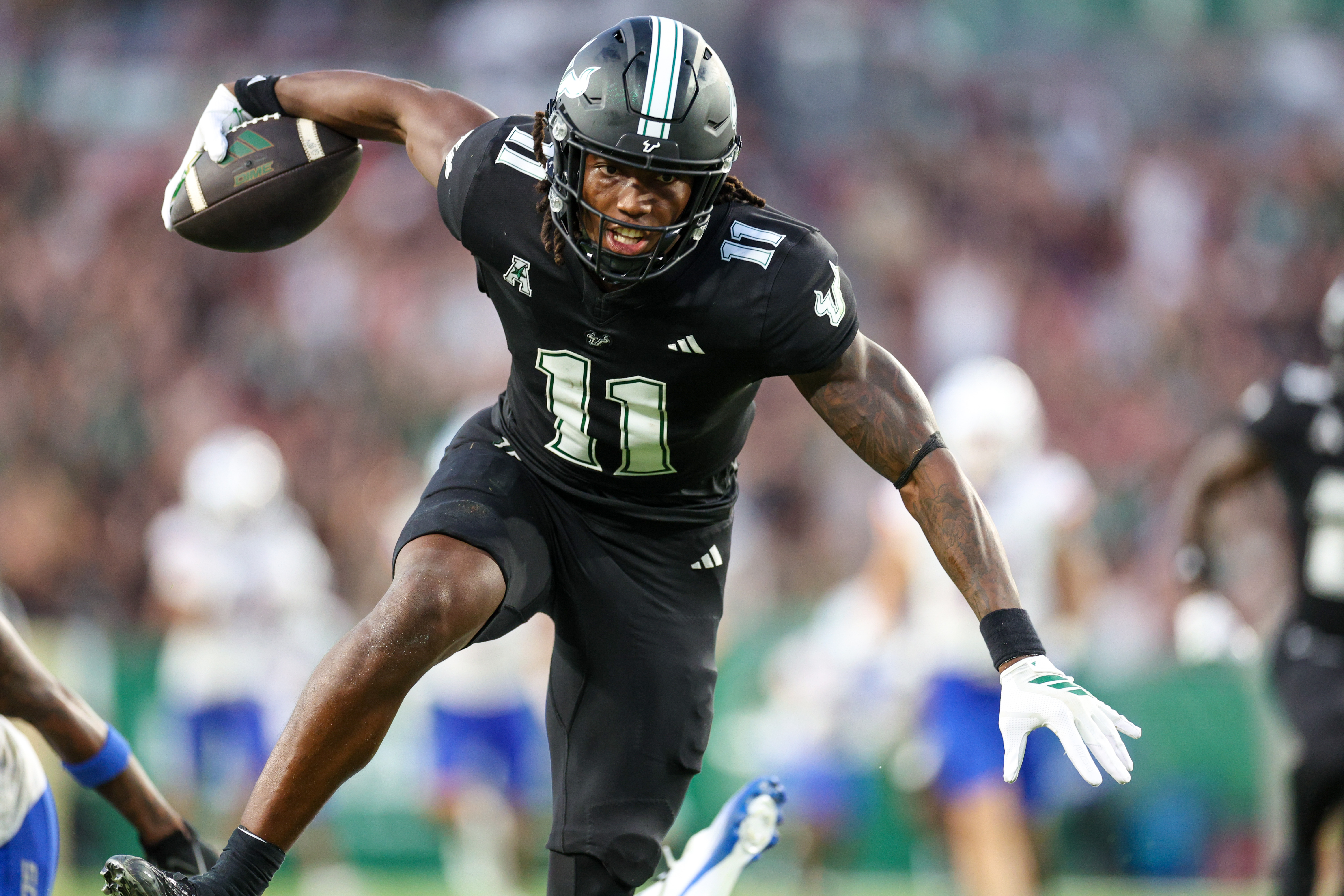 South Florida Bulls wide receiver Keshaun Singleton (11), seen here running with the ball, is featured in our Old Dominion vs. South Florida predictions for the 2025 Cure Bowl.