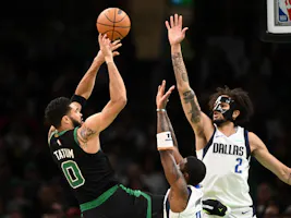 Jayson Tatum of the Boston Celtics attempts a basket against Kyrie Irving of the Dallas Mavericks and Dereck Lively II during the second quarter at the TD Garden. We're breaking down the Jayson Tatum odds ahead of Game 1 of the NBA Finals.