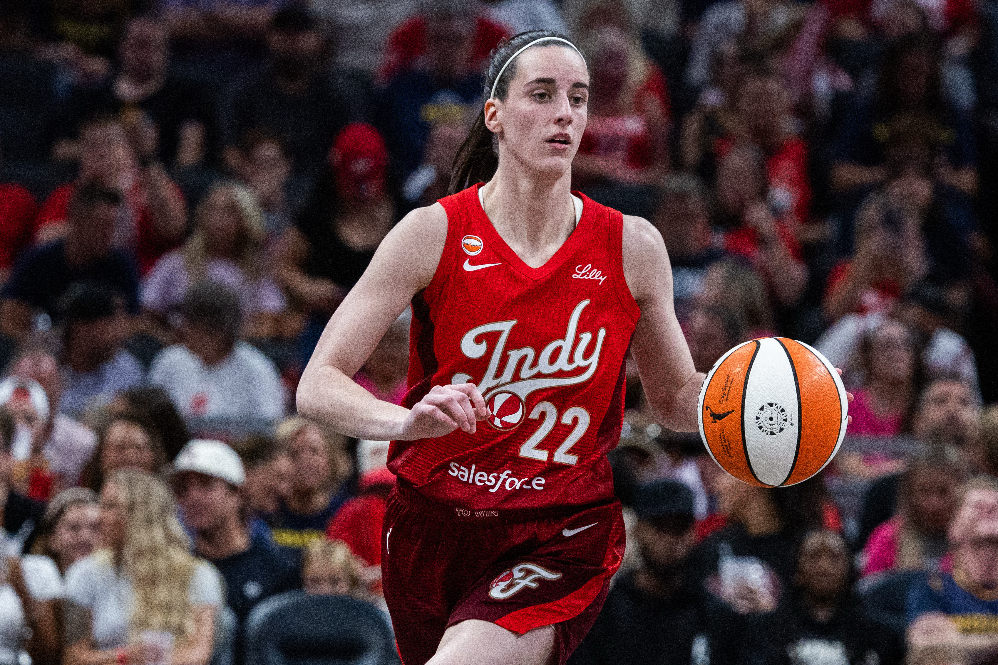 Indiana Fever guard Caitlin Clark (22) dribbles the ball as she is featured in our Liberty vs. Lynx prediction.