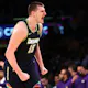 Nikola Jokic of the Denver Nuggets reacts after scoring and we offer our top odds and SGP picks for Monday's NBA games.