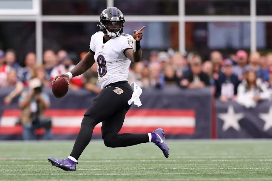 Quarterback Lamar Jackson of the Baltimore Ravens carries the ball against the New England Patriots, and we offer new U.S. bettors our exclusive bet365 bonus code for NFL Week 3.