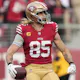 San Francisco 49ers George Kittle celebrates a touchdown as we look at the Super Bowl injury report and track the latest injury updates and betting odds for Chiefs vs. 49ers in Super Bowl 58.