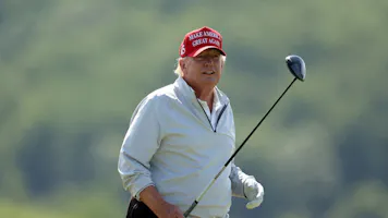 Former President Donald Trump follows his tee shot during the pro-am prior to the LIV Golf Invitational - DC at Trump National Golf Club as we look at our 2024 U.S. presidential election odds.