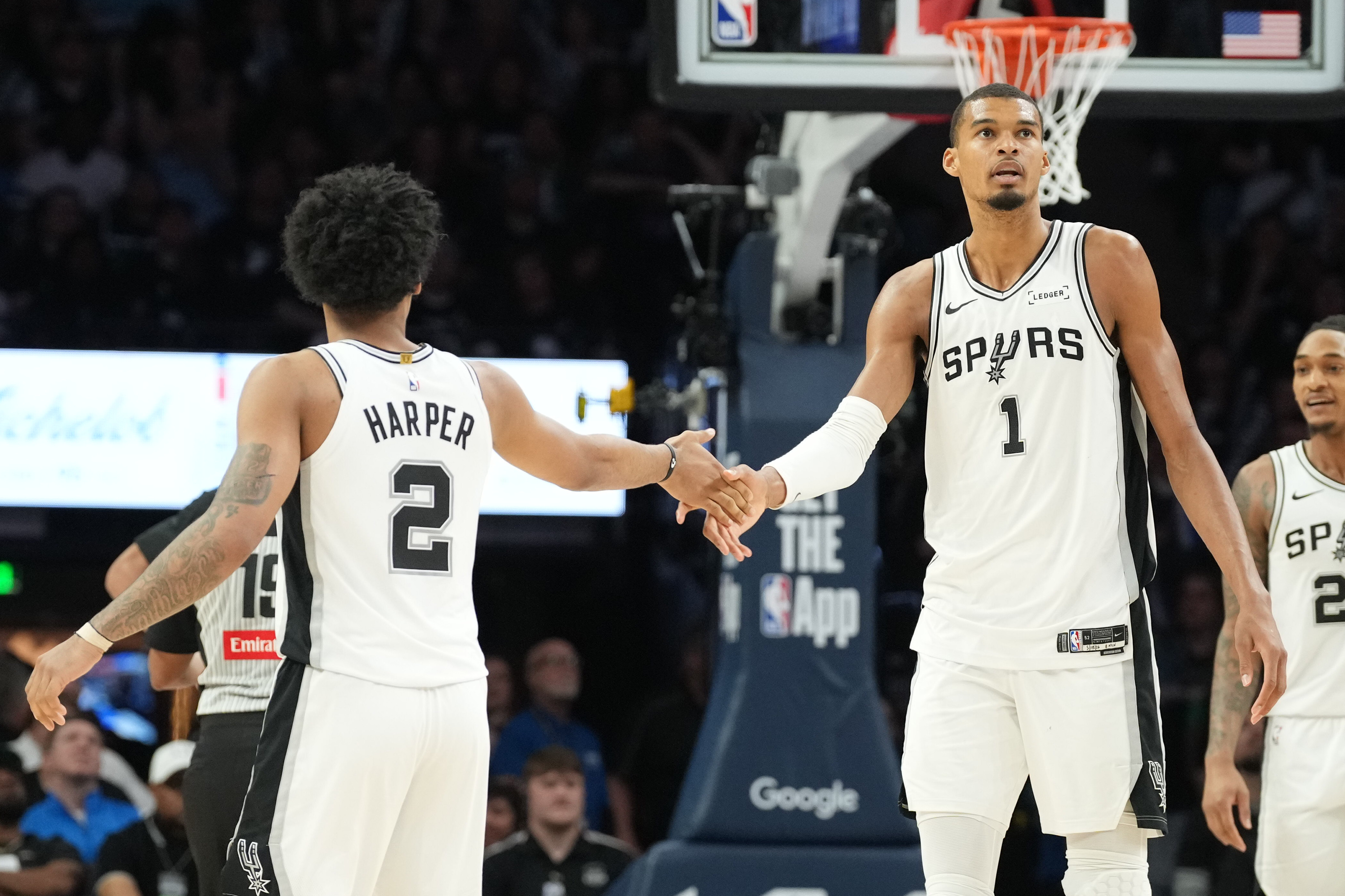 San Antonio Spurs forward Victor Wembanyama (1) shakes hands with San Antonio Spurs guard Dylan Harper (2) as we break down our NBA Play of the Day.