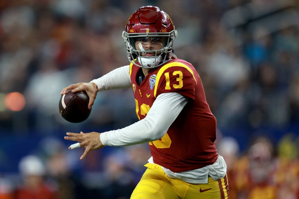 ARLINGTON, TEXAS - JANUARY 02: Caleb Williams #13 of the USC Trojans throws a touchdown pass against the Tulane Green Wave in the second quarter of the Goodyear Cotton Bowl Classic on January 02, 2023 at AT&T Stadium in Arlington, Texas.