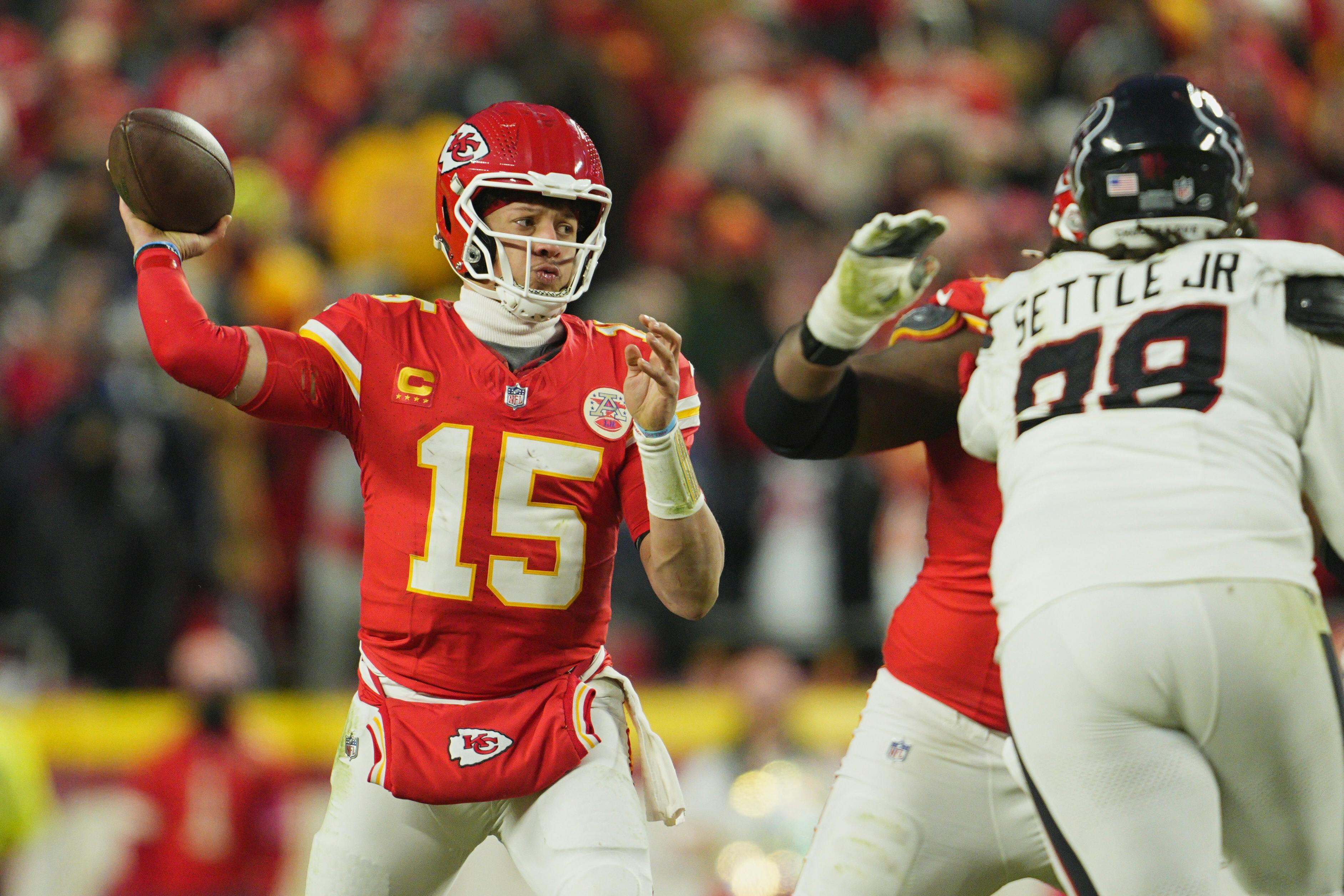 Kansas City Chiefs quarterback Patrick Mahomes runs the ball against the Houston Texans as we dive into our Allen vs. Mahomes comparison.