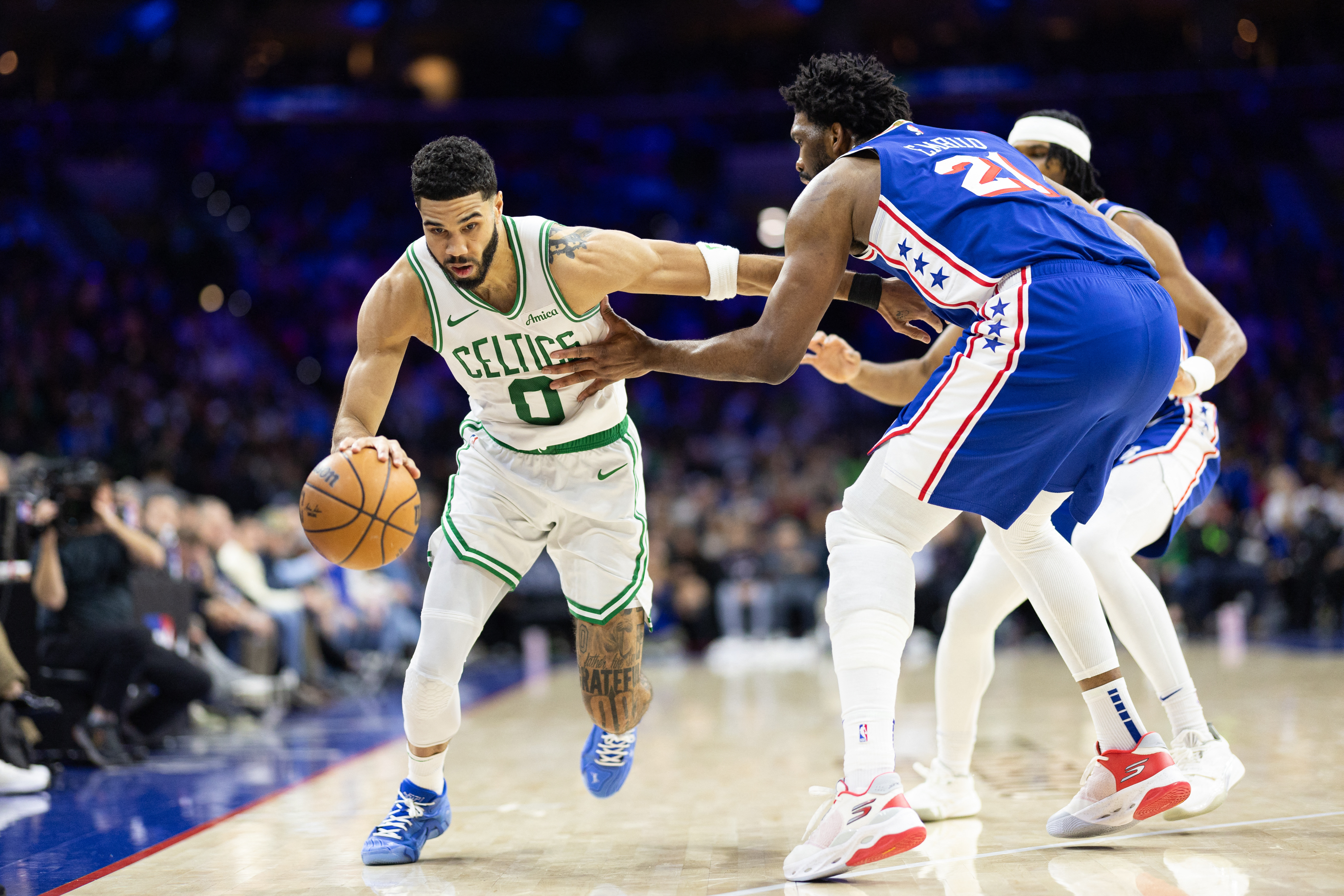 Boston Celtics forward Jayson Tatum (0) drives against Philadelphia 76ers center Joel Embiid (21) at Wells Fargo Center.