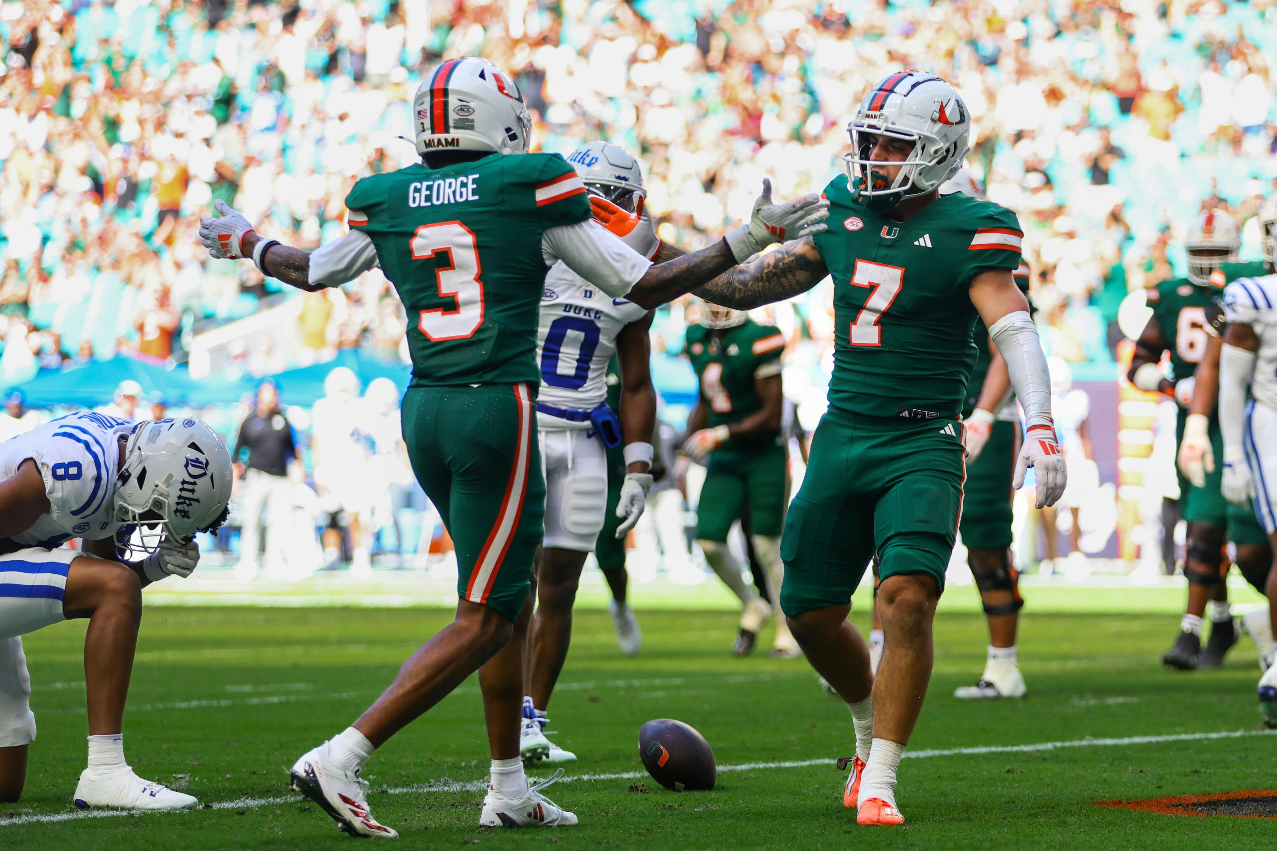 Miami wide receiver Xavier Restrepo celebrates with wide receiver Jacolby George after scoring a touchdown against Duke. The Hurricanes lead the ACC Championship odds.