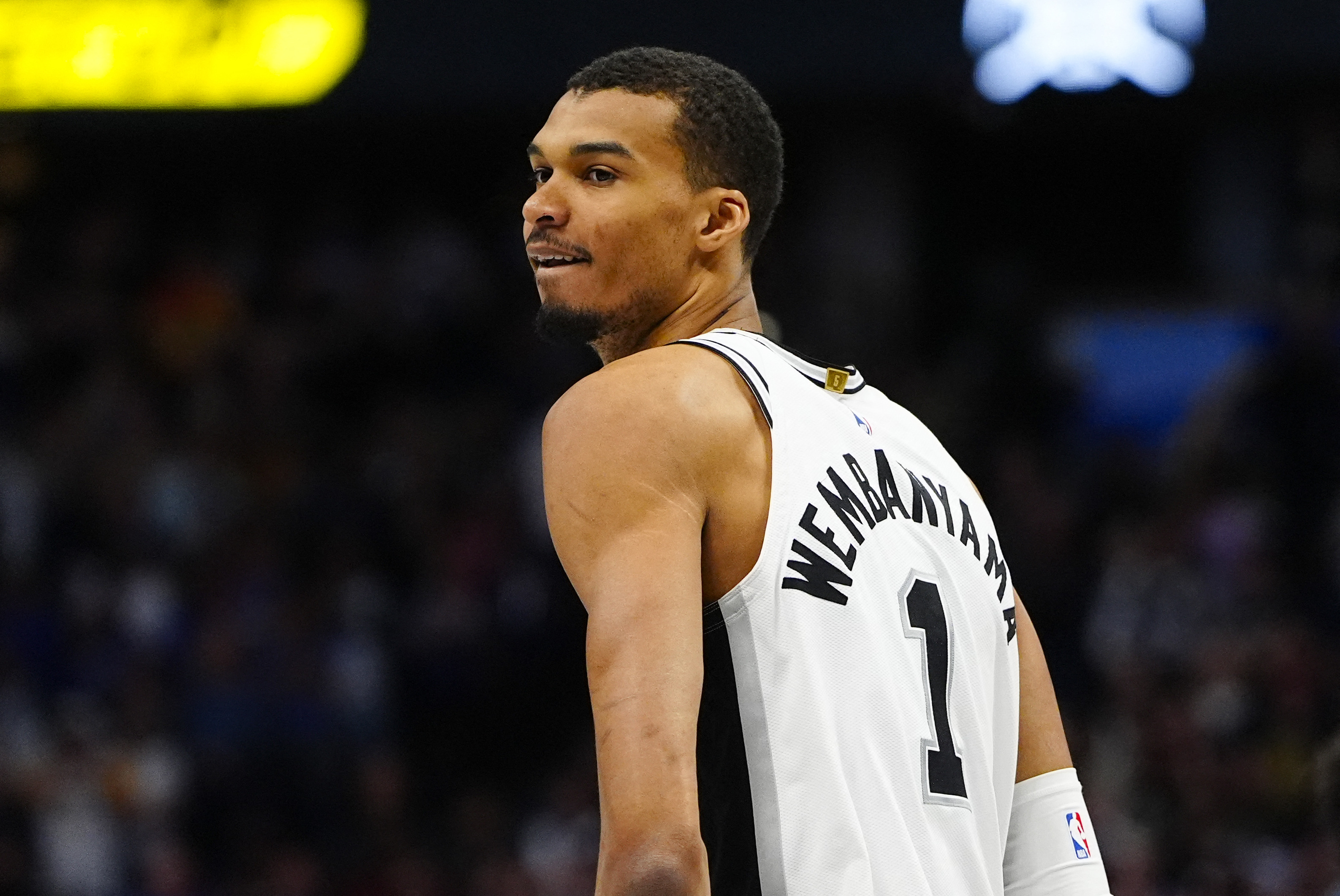 San Antonio Spurs forward Victor Wembanyama (1) reacts back to the Denver Nuggets bench in the first quarter at Ball Arena. 