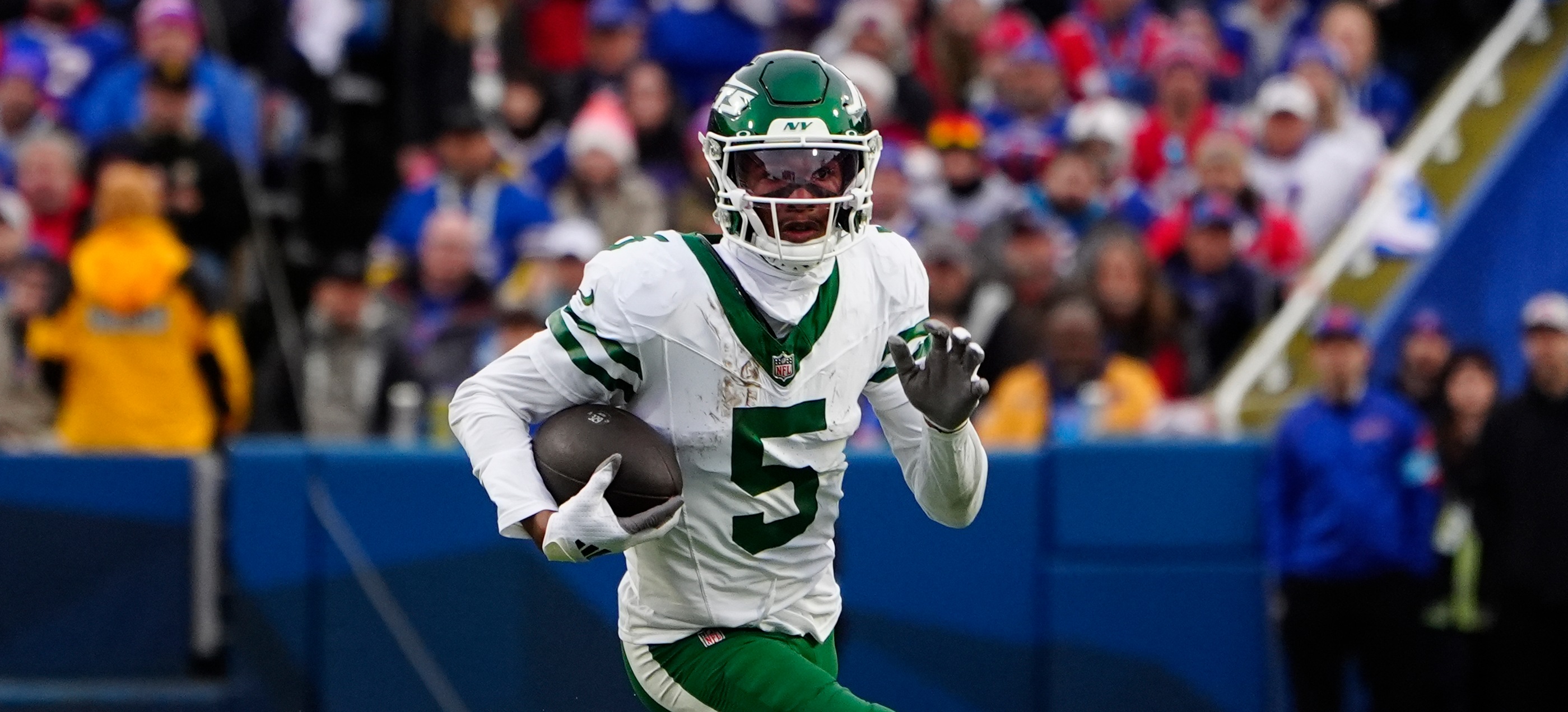 New York Jets wide receiver Garrett Wilson (5) runs with the ball after making a catch against the Buffalo Bills during the second half at Highmark Stadium as we look at a Garrett Wilson injury update