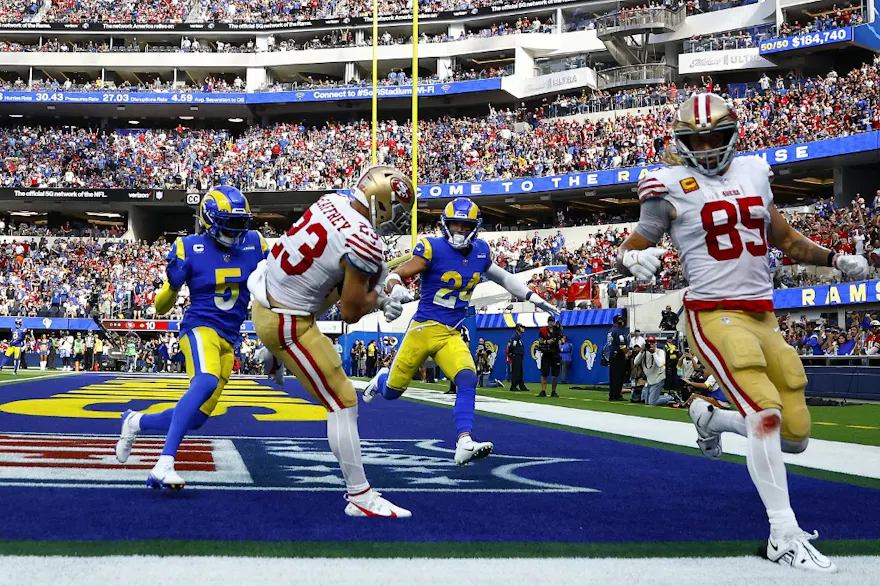 Christian McCaffrey of the San Francisco 49ers catches the ball for a touchdown as Jalen Ramsey and Taylor Rapp of the Los Angeles Rams defend at SoFi Stadium on Oct. 30, 2022 in Inglewood, California. 