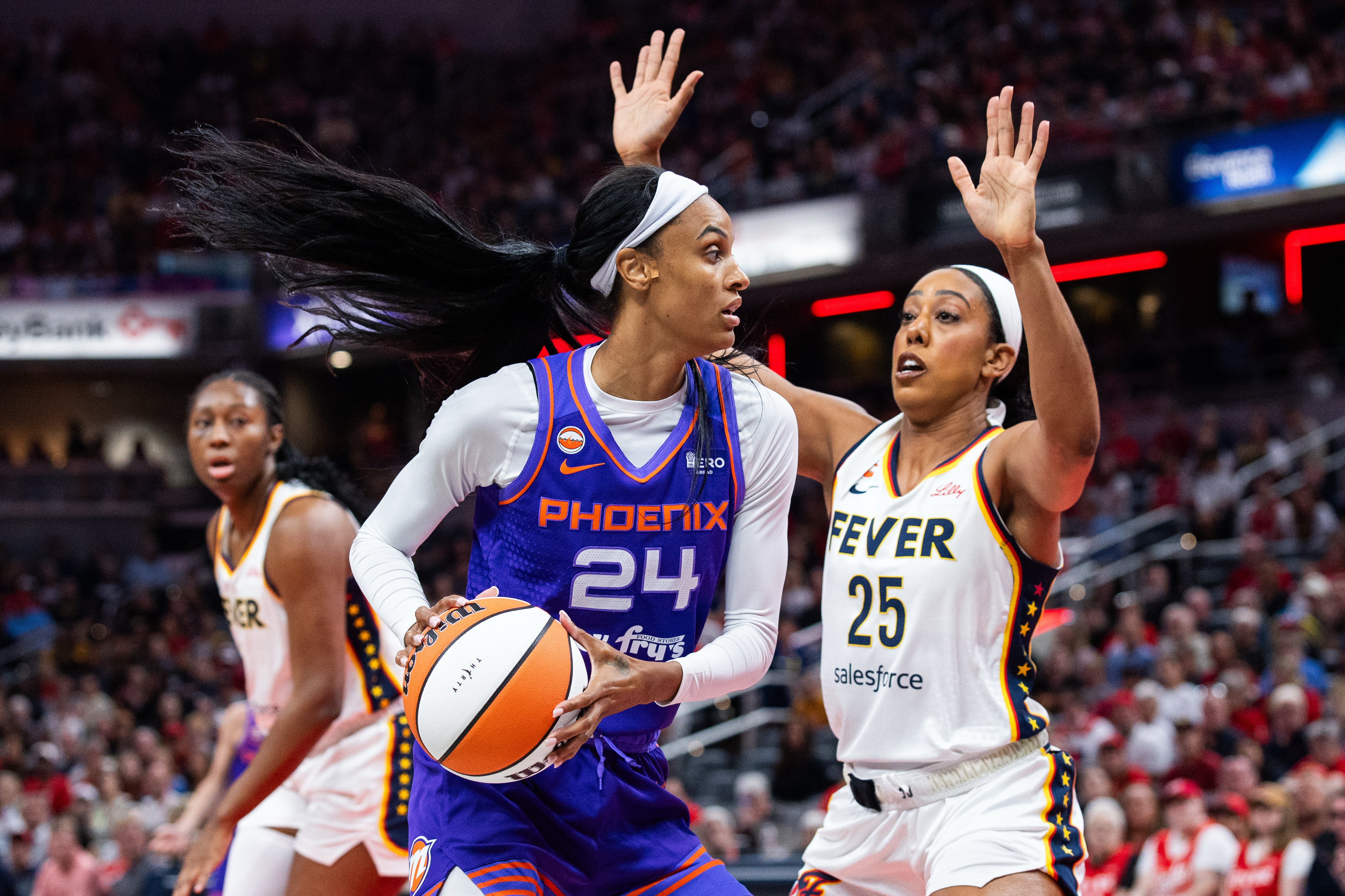Phoenix Mercury forward DeWanna Bonner (24) holds the ball against Indiana Fever forward Monique Billings (25) as we break down our Fever vs. Mercury prediction.