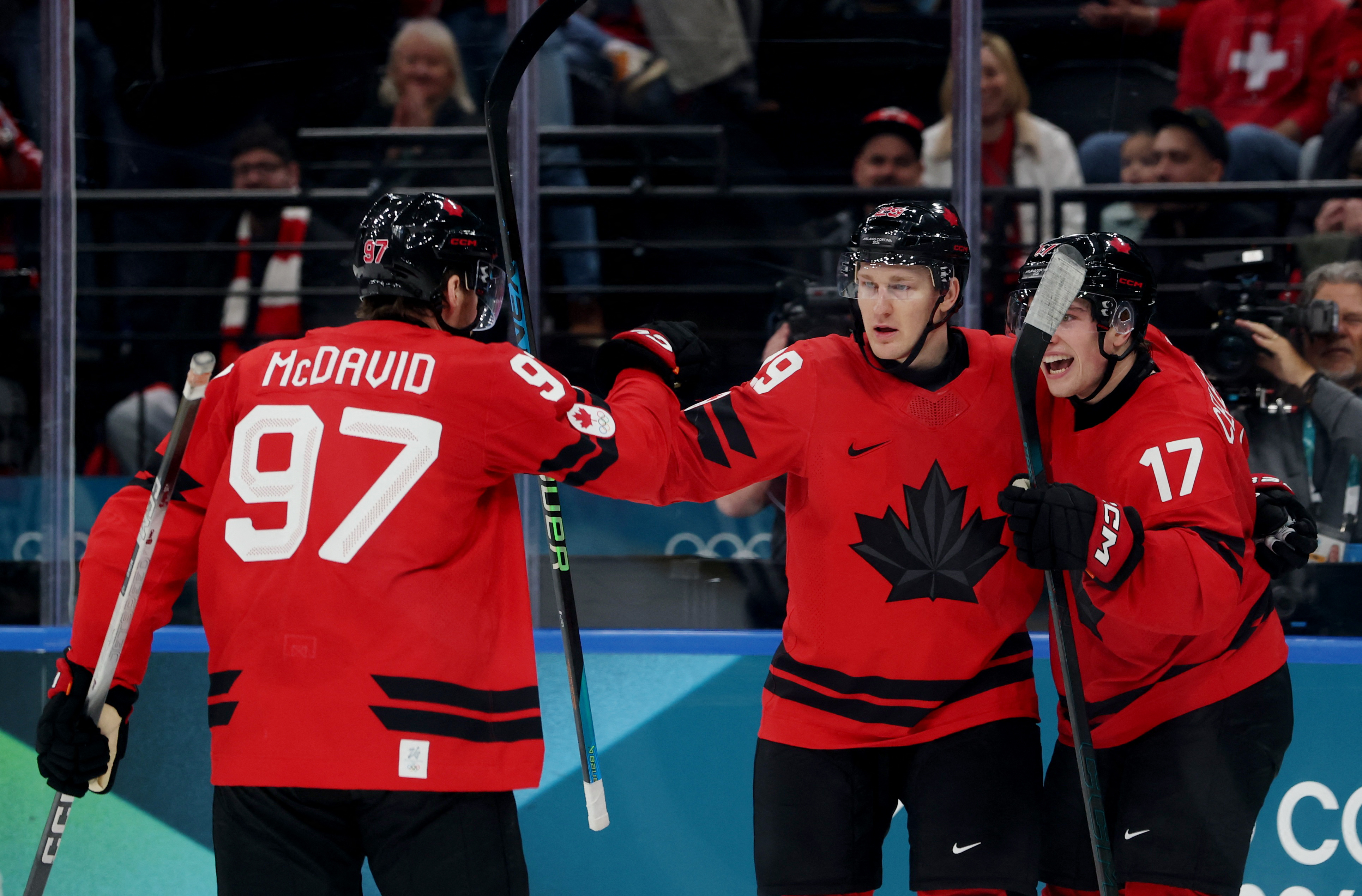 Nathan MacKinnon celebrates with Macklin Celebrini and Connor McDavid as we provide the men's Olympic hockey odds and predictions.