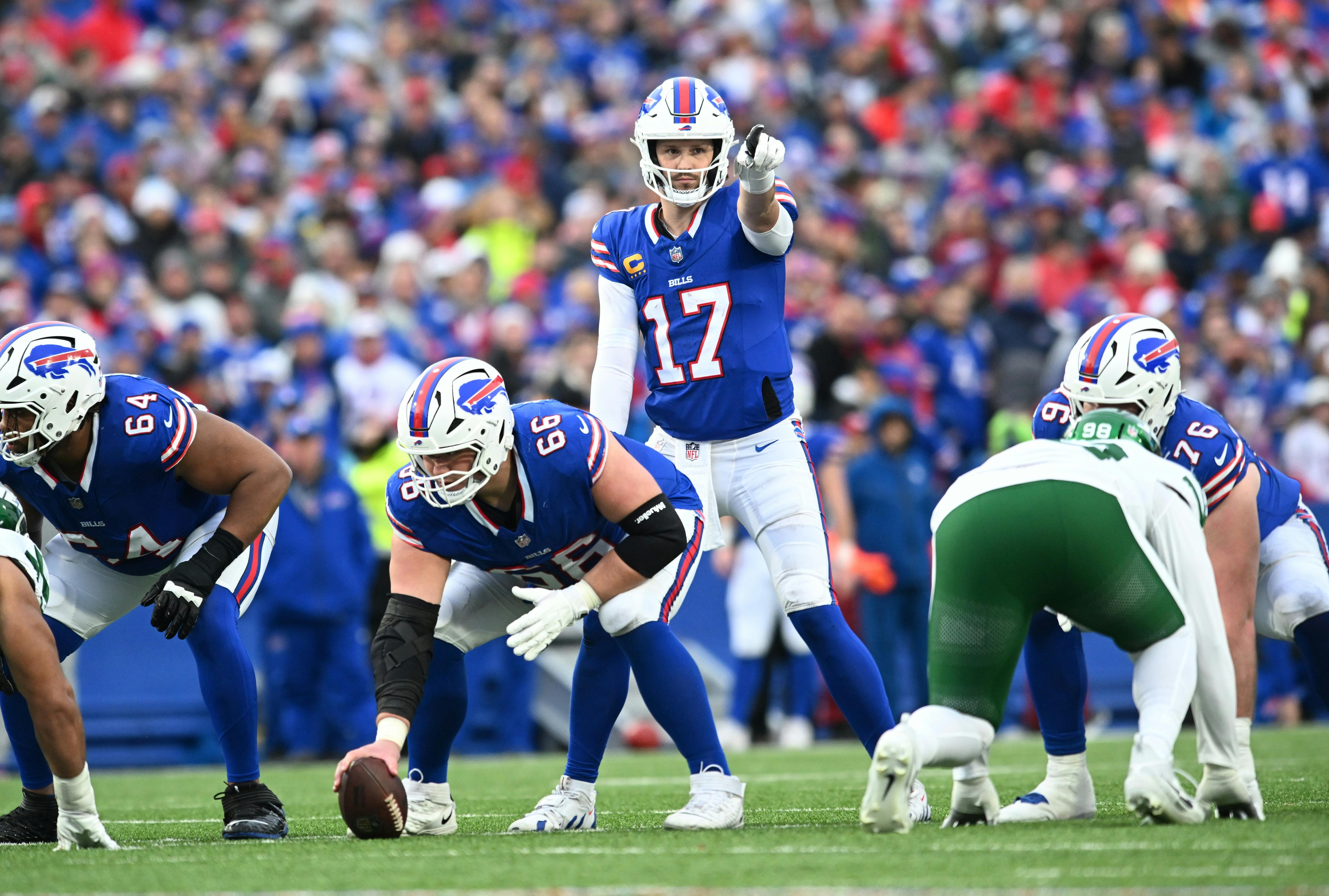 Buffalo Bills quarterback Josh Allen (17) and guard Connor McGovern (66) at the line of scrimmage as we look at our NFL playoff bracket predictions.