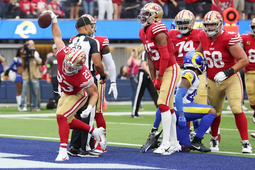 Christian McCaffrey of the San Francisco 49ers reacts to a touchdown during the first quarter against the Los Angeles Rams, and we offer our top odds and predictions for NFL Offensive Player of the Year based on the best NFL odds.