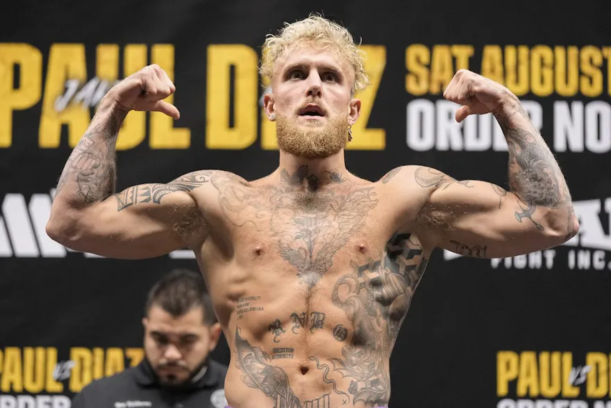 Jake Paul gestures to the crowd during weigh-ins for his fight against Nate Diaz, and we provide new bettors with our exclusive promo code for DraftKings ahead of the fight.