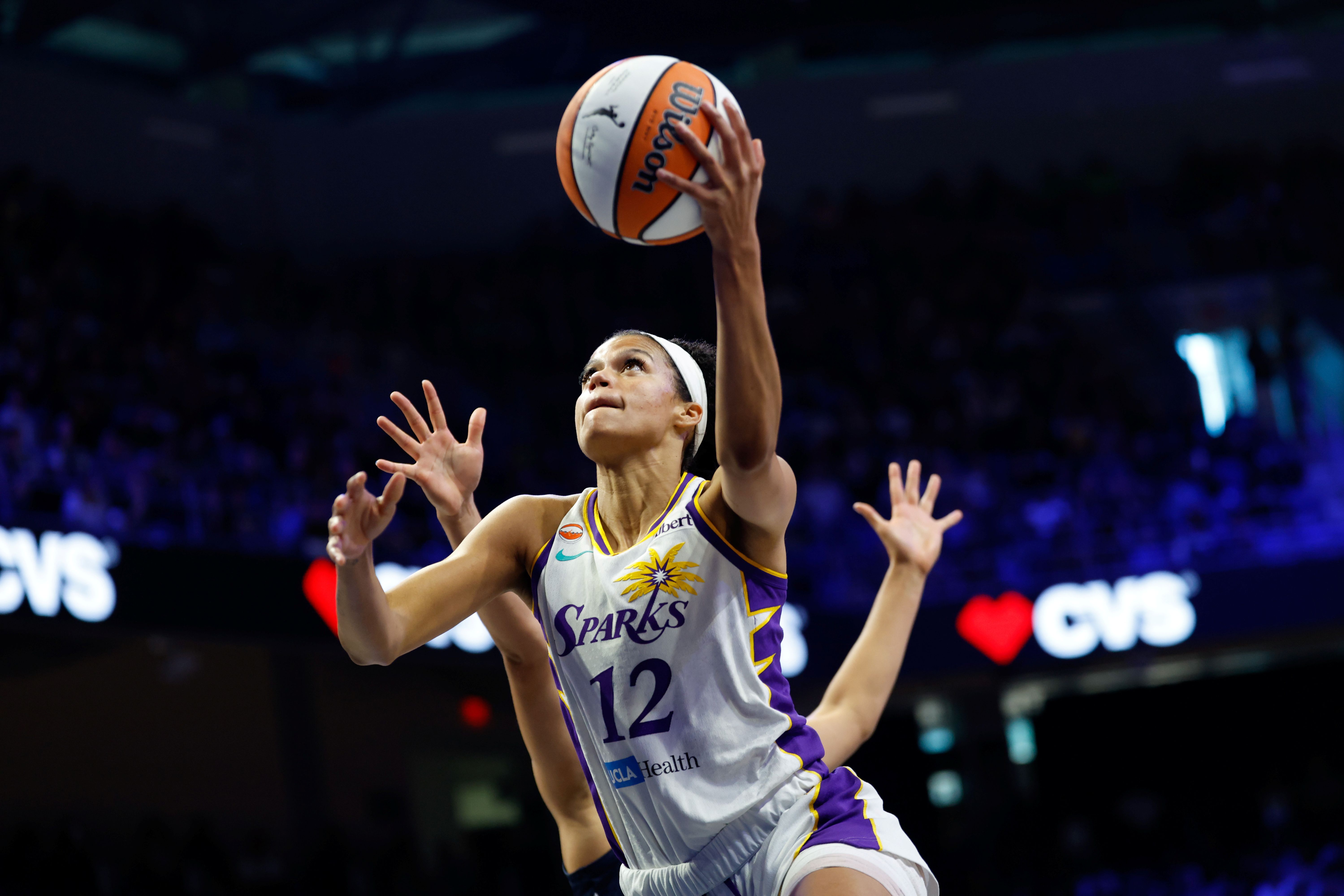 Los Angeles Sparks guard Rae Burrell (12) scores a basket as we break down our Valkyries vs. Sparks prediction.