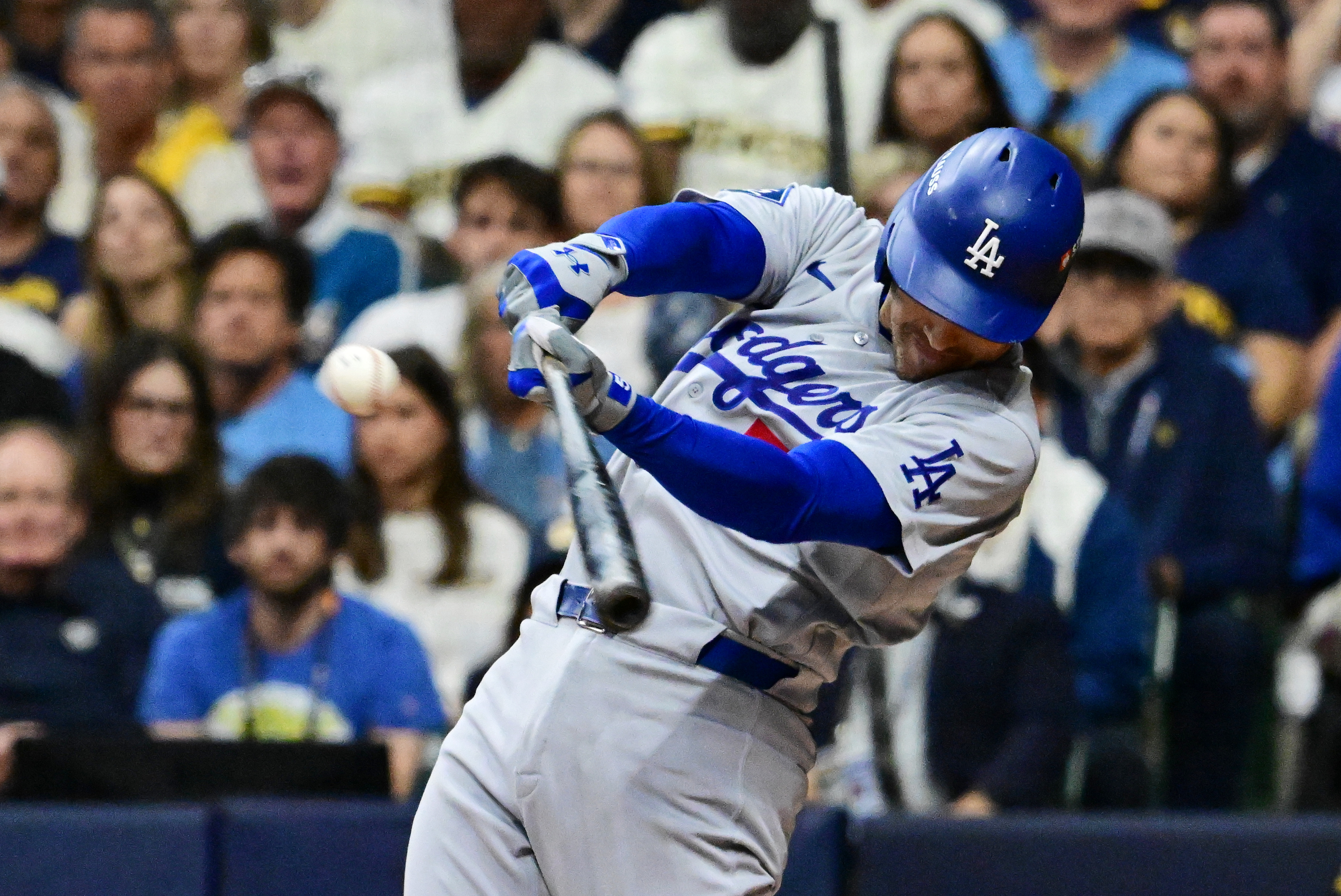  Los Angeles Dodgers first baseman Freddie Freeman (5) hits a single against the Milwaukee Brewers as we make our best Brewers vs. Dodgers prediction.