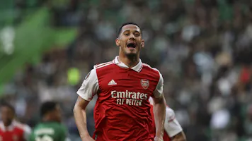 Arsenal defender William Saliba celebrates after scoring his team's first goal during the UEFA Europa League and we offer our best odds and picks for Fulham vs. Arsenal.