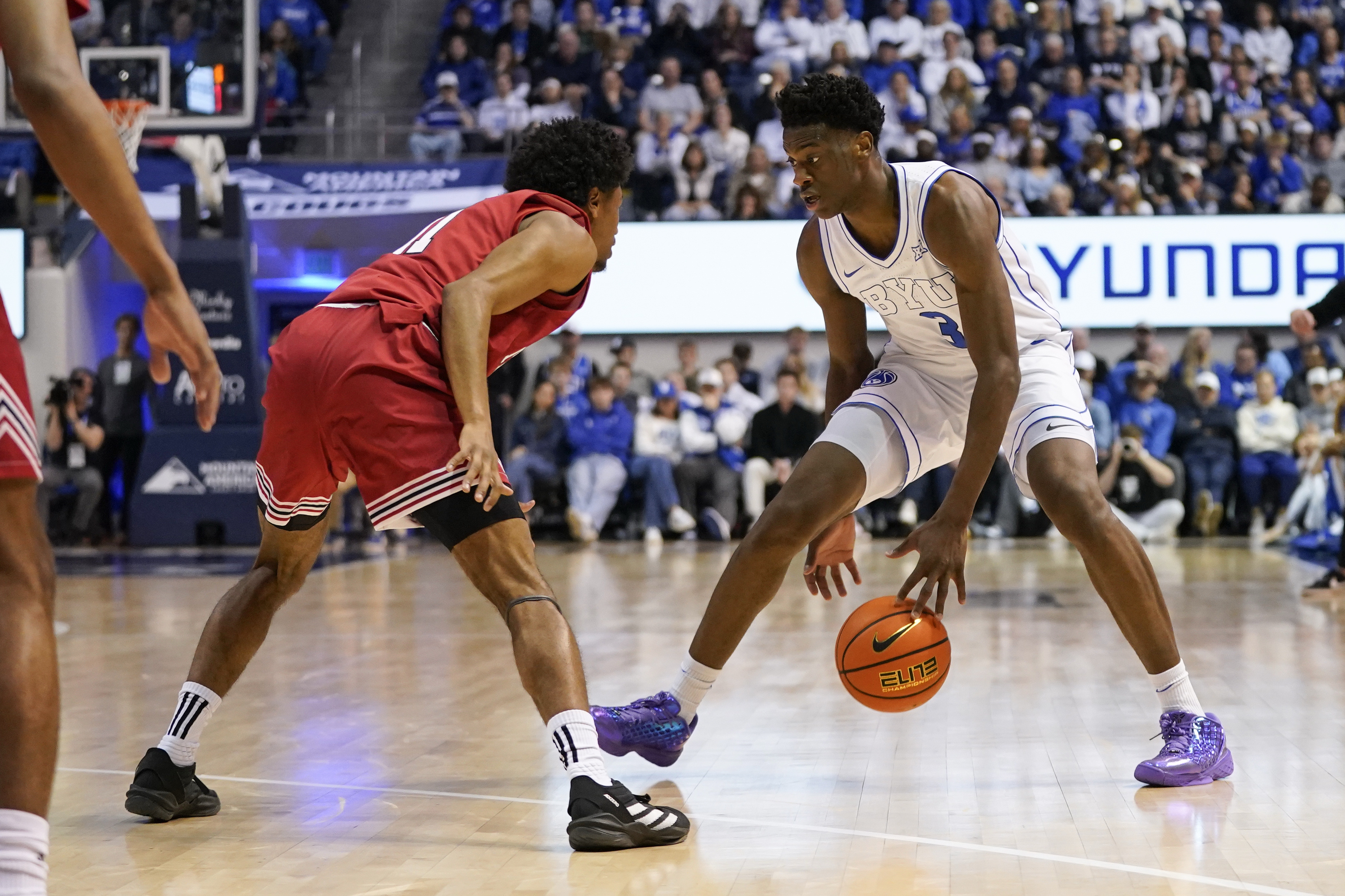 BYU Cougars forward AJ Dybantsa (3), who is featured in our college basketball predictions today, dribbles the ball while being defended by Texas Tech Red Raiders guard Jaylen Petty (11).